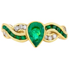 1980s Center Pear Shape Emerald with Round Emeralds and Diamonds Ring