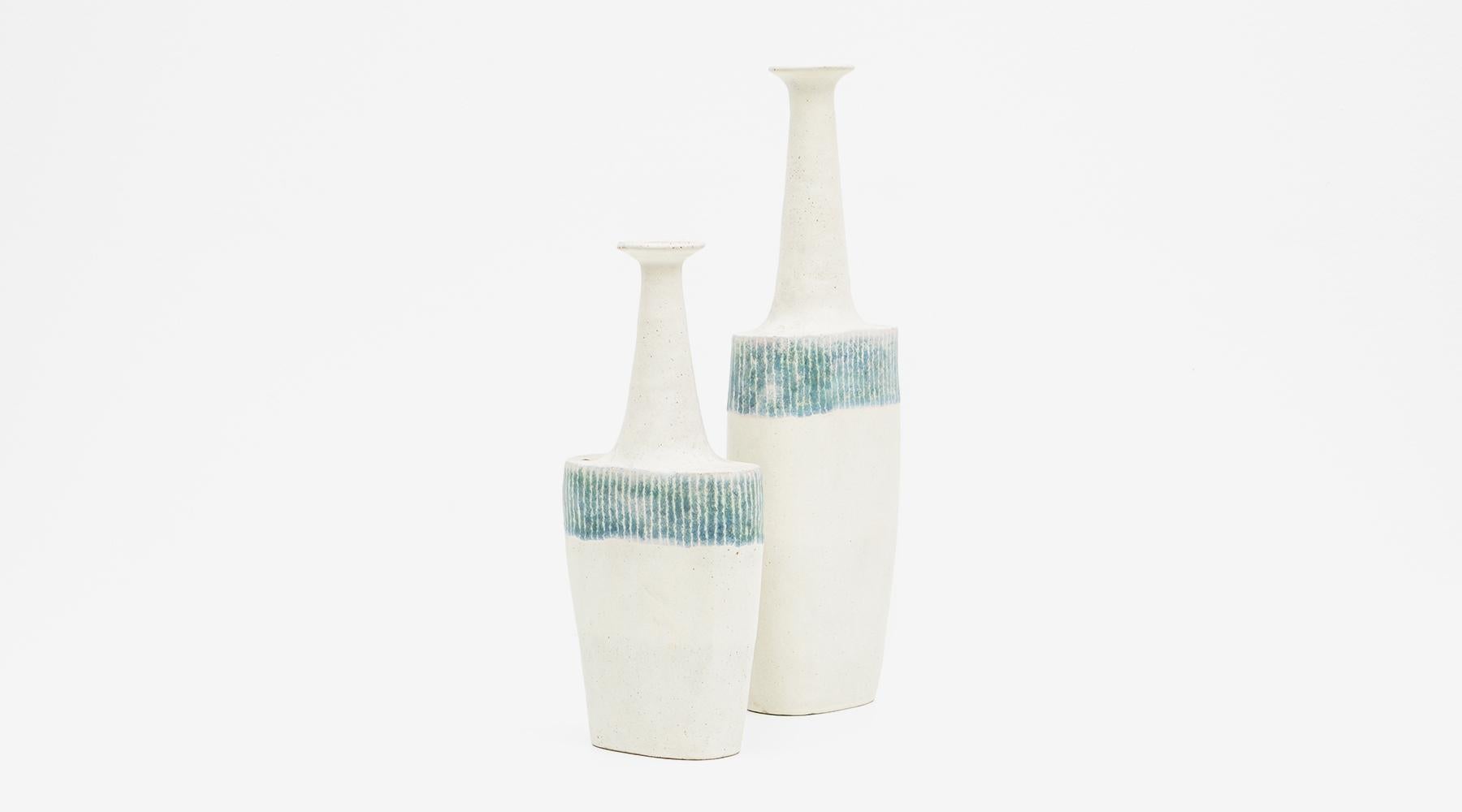 Set of two vases, ceramic, glazed, Bruno Gambone, Italy, 1970s.

Marvelous set of two oval bottles made by the multi-talented artist Bruno Gambone in 1980, varying in height but the width is the same. The vases come in a warm sand tone, on the