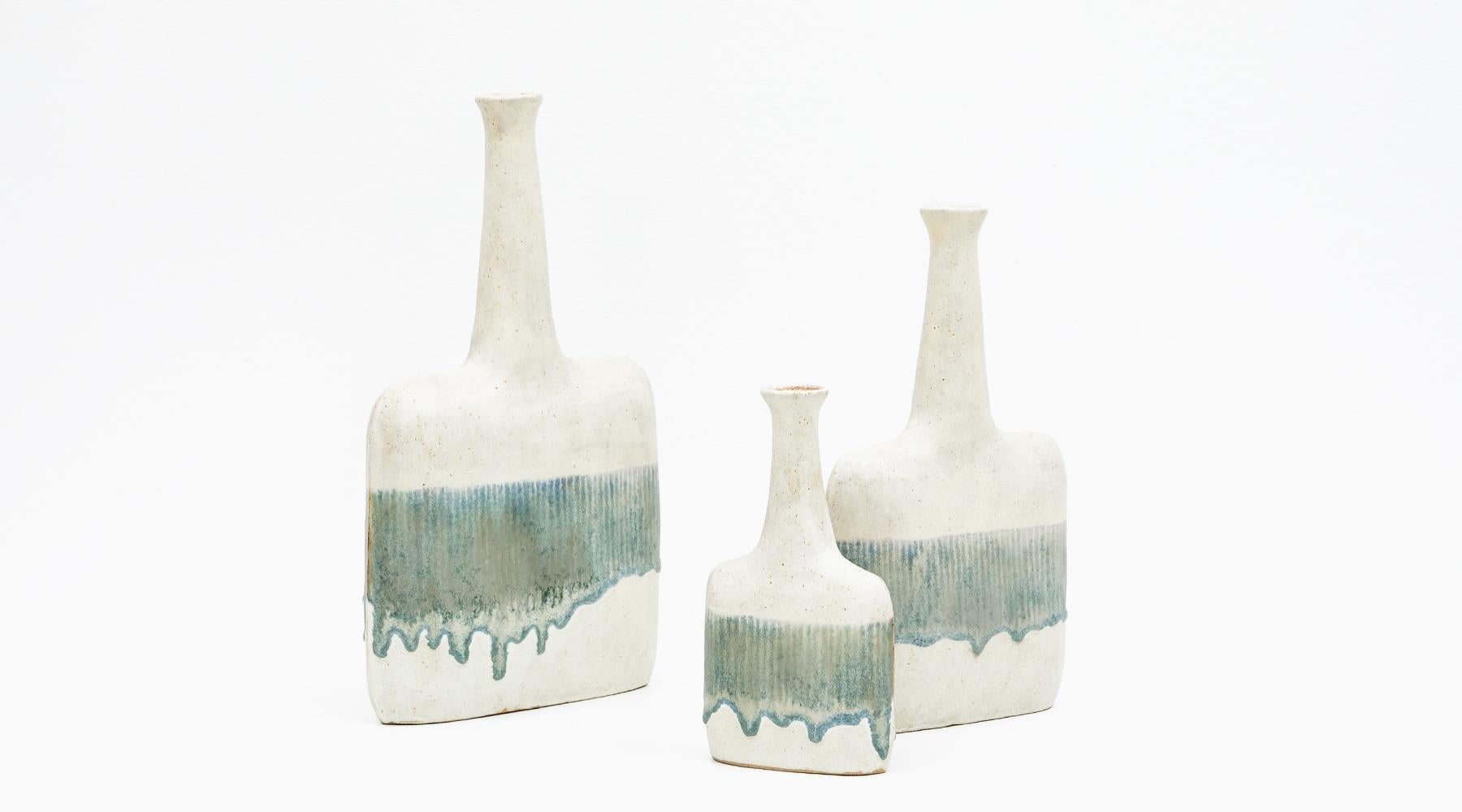Warm beige and sea tones, set of three vases, ceramic, Bruno Gambone, Italy, 1980s.

Lovely set of ceramic objects by the versatile artist Bruno Gambone from the 1980s. They vary in height and width. Each vase has a long narrow neck in contrast to