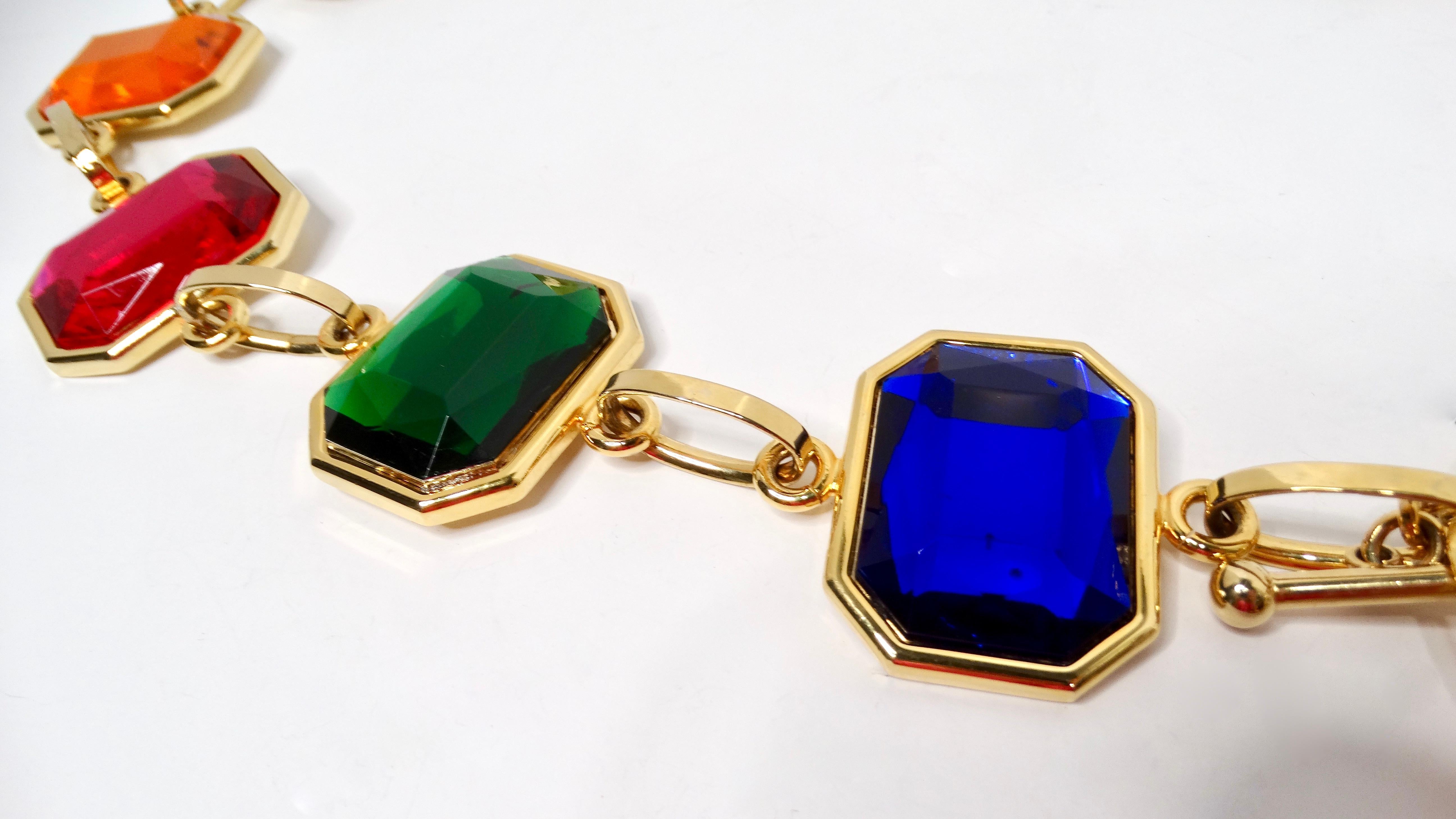 Elevate your wardrobe with this stunning 1980s Chain Link Multicolor Jewel-Tone Belt, a truly bold and heavy statement piece that is sure to draw attention. Crafted from costume jewels in ornate hues of blue, red, green, and pink, this belt serves