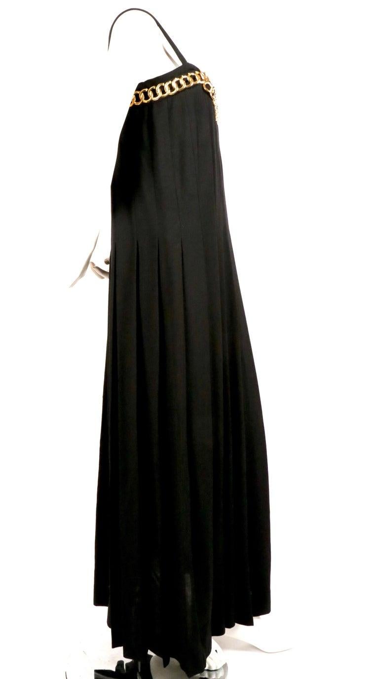 Very rare, jet-black wool crepe, hand-pleated gown with gilt chain detail at bodice designed by Karl Lagerfeld for Chanel dating to the late 1980's. Labeled a French 40 however this best fits a modern day FR 36 or 38 or US 4-6. Dress is fitted at