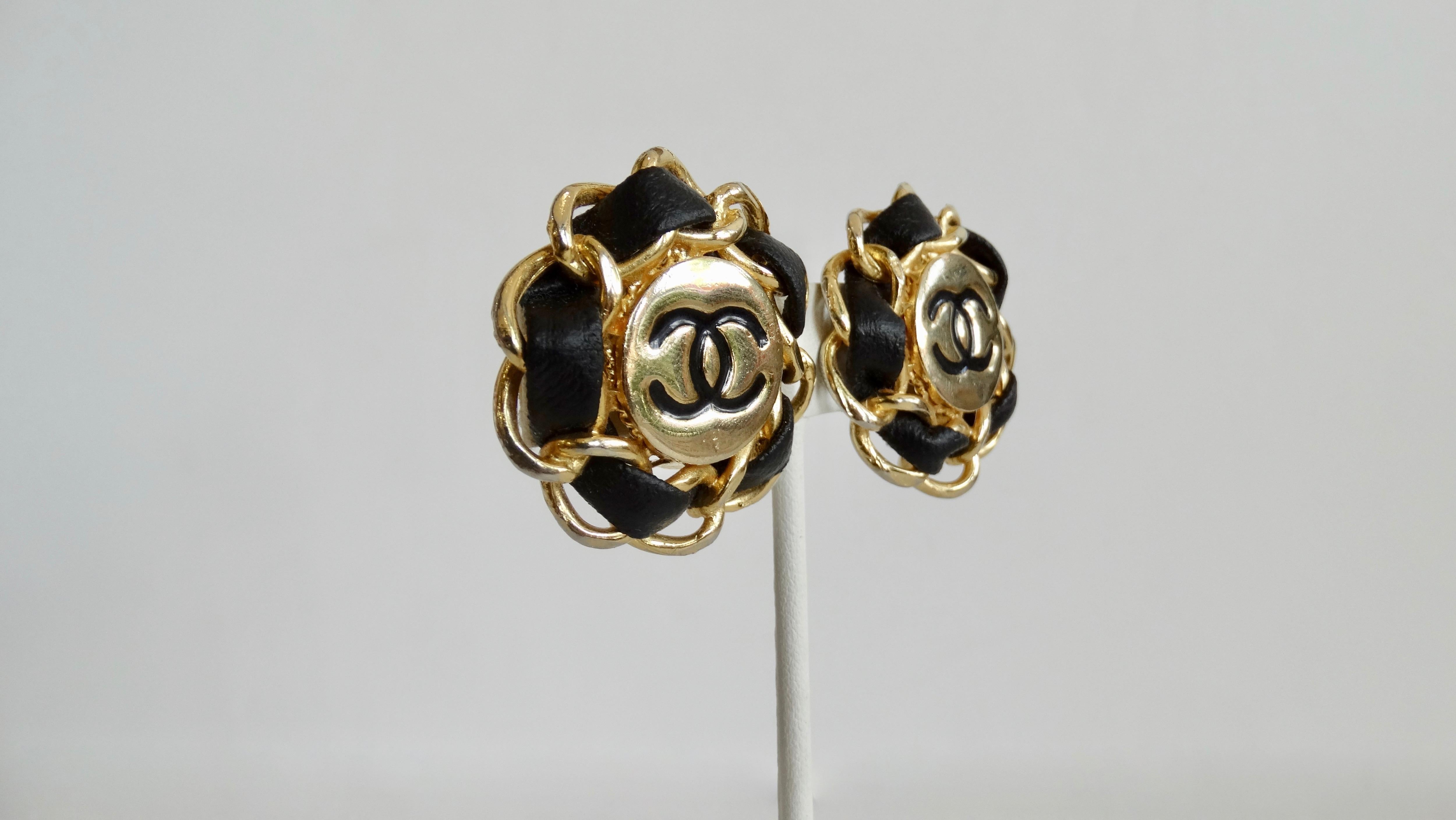 Be the ultimate Chanel girl with these classic earrings! Circa 1980s, these gold plated earrings feature the iconic 'CC' logo in the center and the intertwined chain and leather boarder is modeled after Chanel's signature chain and leather bag