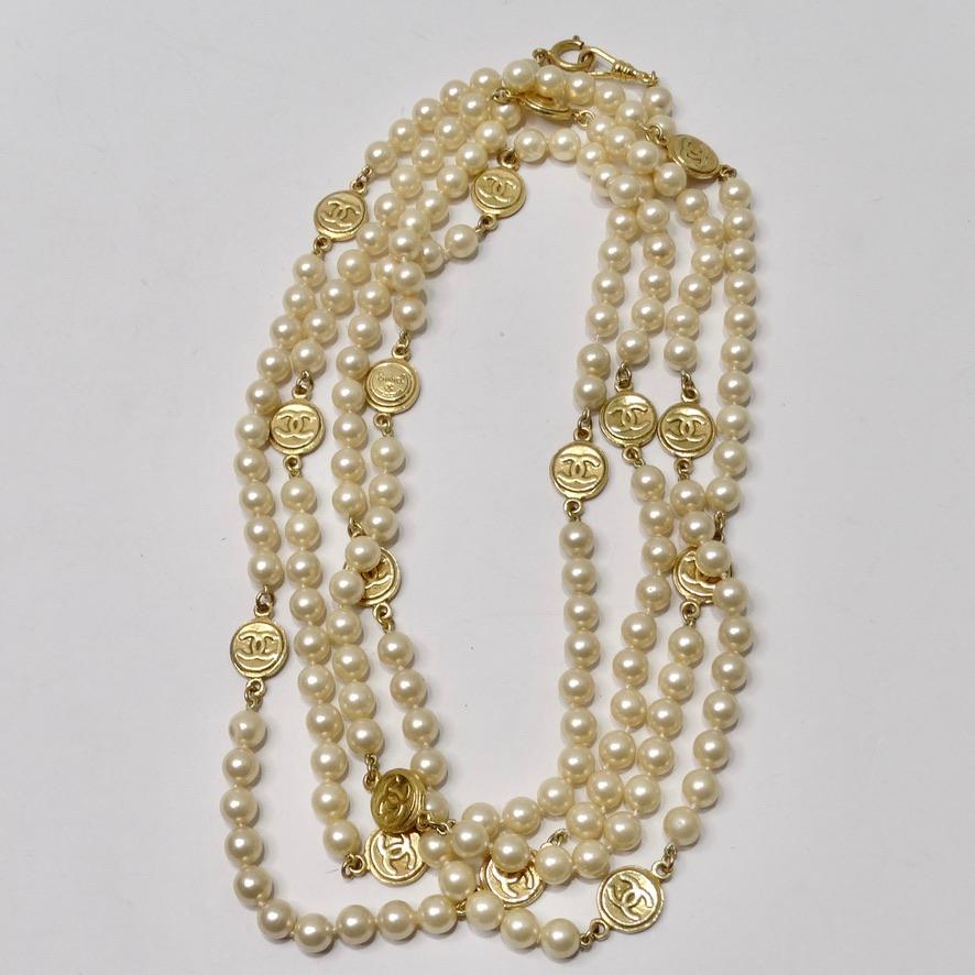 How incredible is this extremely rare 1980s Chanel extra long pearl necklace? Chanel proves once again how to master the perfect blend of drama and elegance with this iconic extra long faux pearl necklace featuring gold plated signature Chanel logo