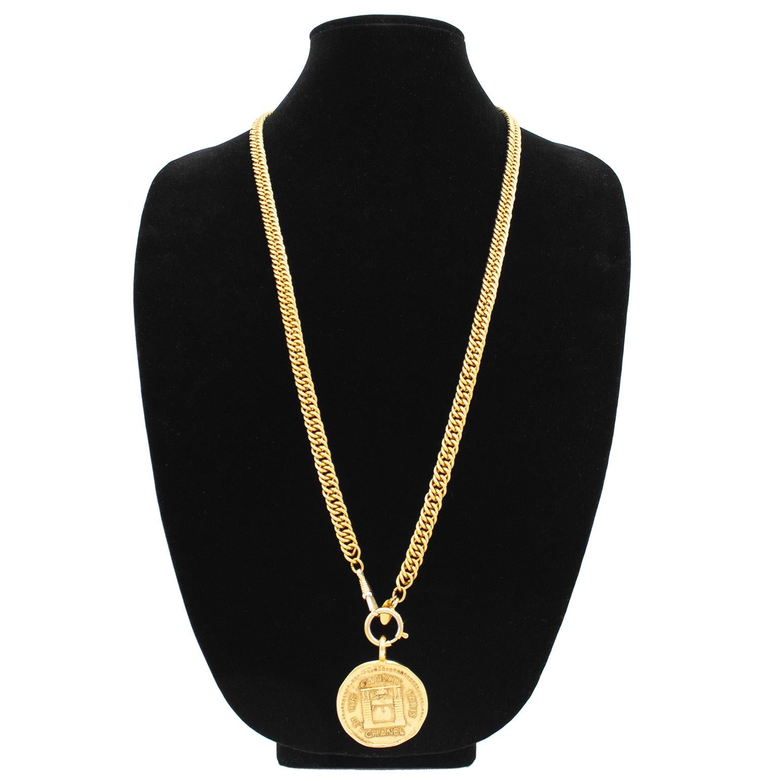 1980s Chanel gold tone metal single strand chainlink necklace with a medallion pendant measuring 1.5