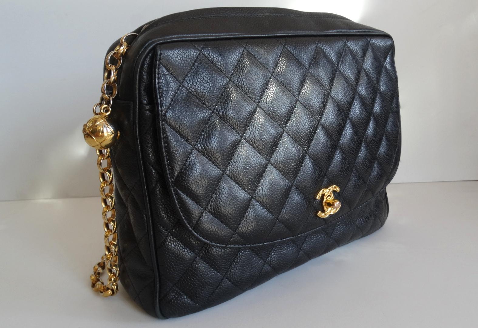 The Chanel Bag Of Your Dreams Is Here! Circa late 1980s, this classic bag features gold hardware and beautiful black caviar leather. Font face of bag includes a quilted textured signature CC mademoiselle turn lock which opens to reveal a flat