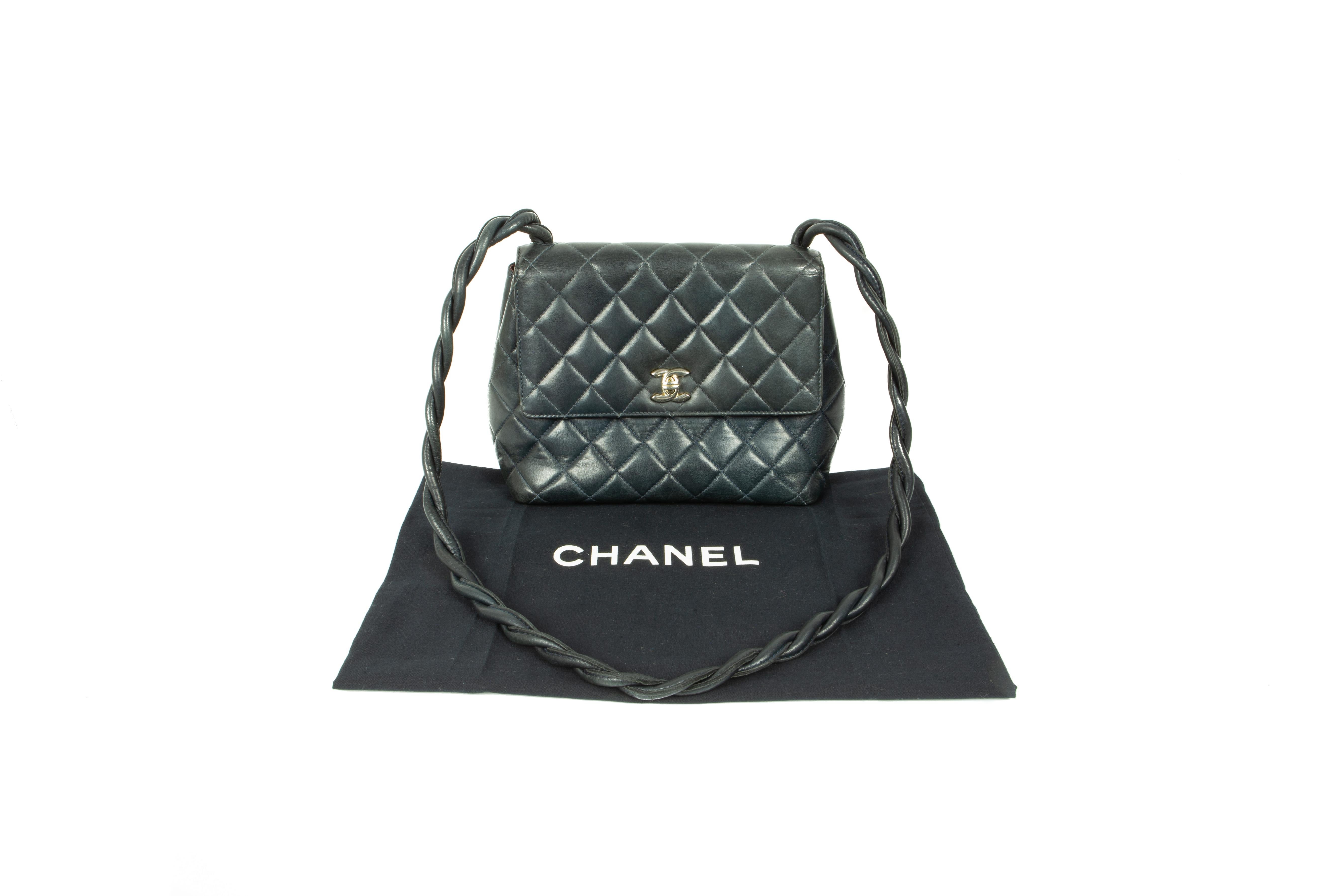 A rare and highly collectable mid-1980s Chanel dark-midnight-blue leather shoulder bag, in the iconic padded and quilted design, comprising of one compartment with one monogram-toggle zipper pocket, one patch pocket and one outer back pocket, fully
