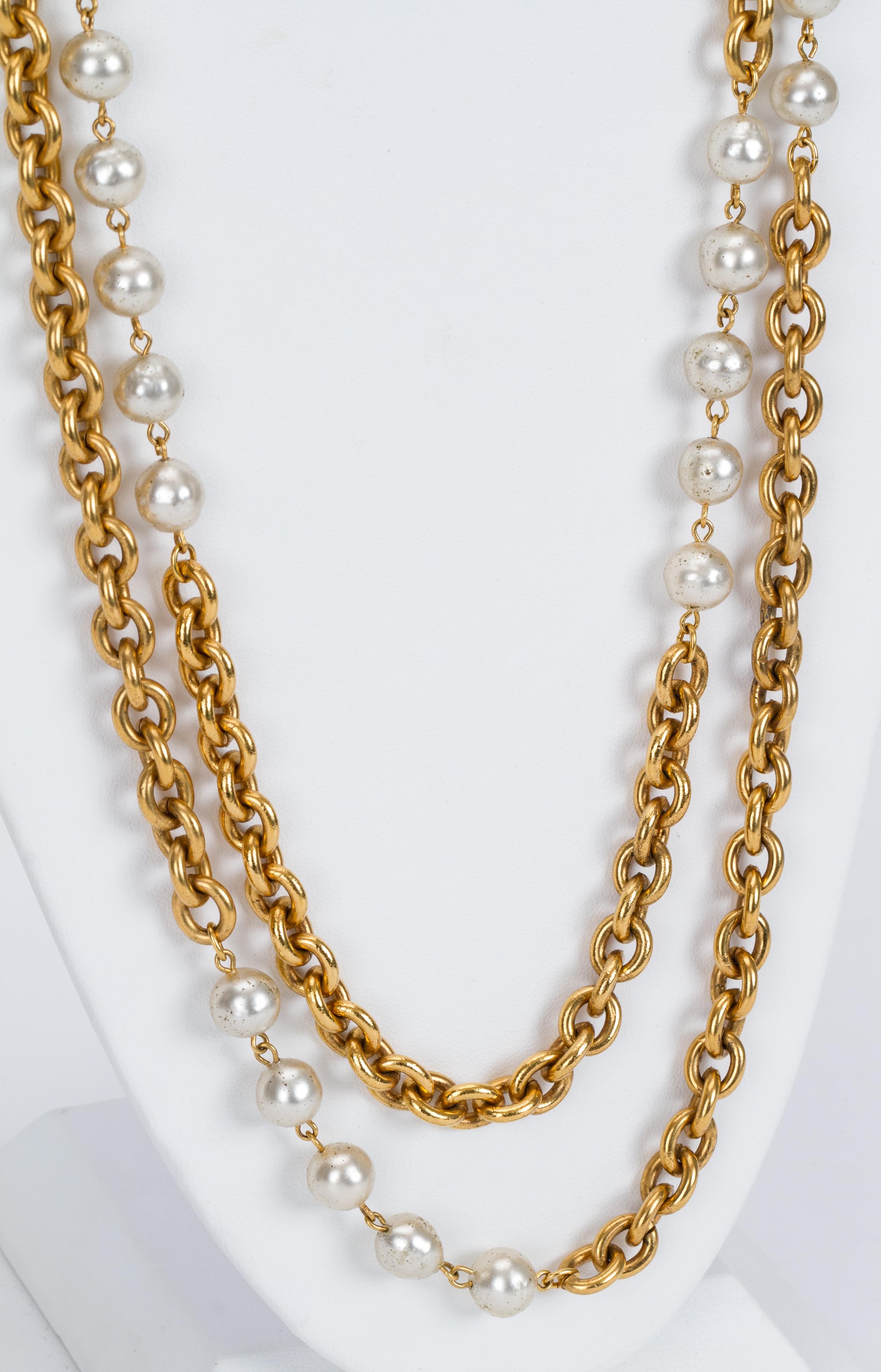 Chanel long double-strand goldtone metal and faux-pearl necklace. 1980s collection. Comes with the original box. Minor darkening on faux-pearls.