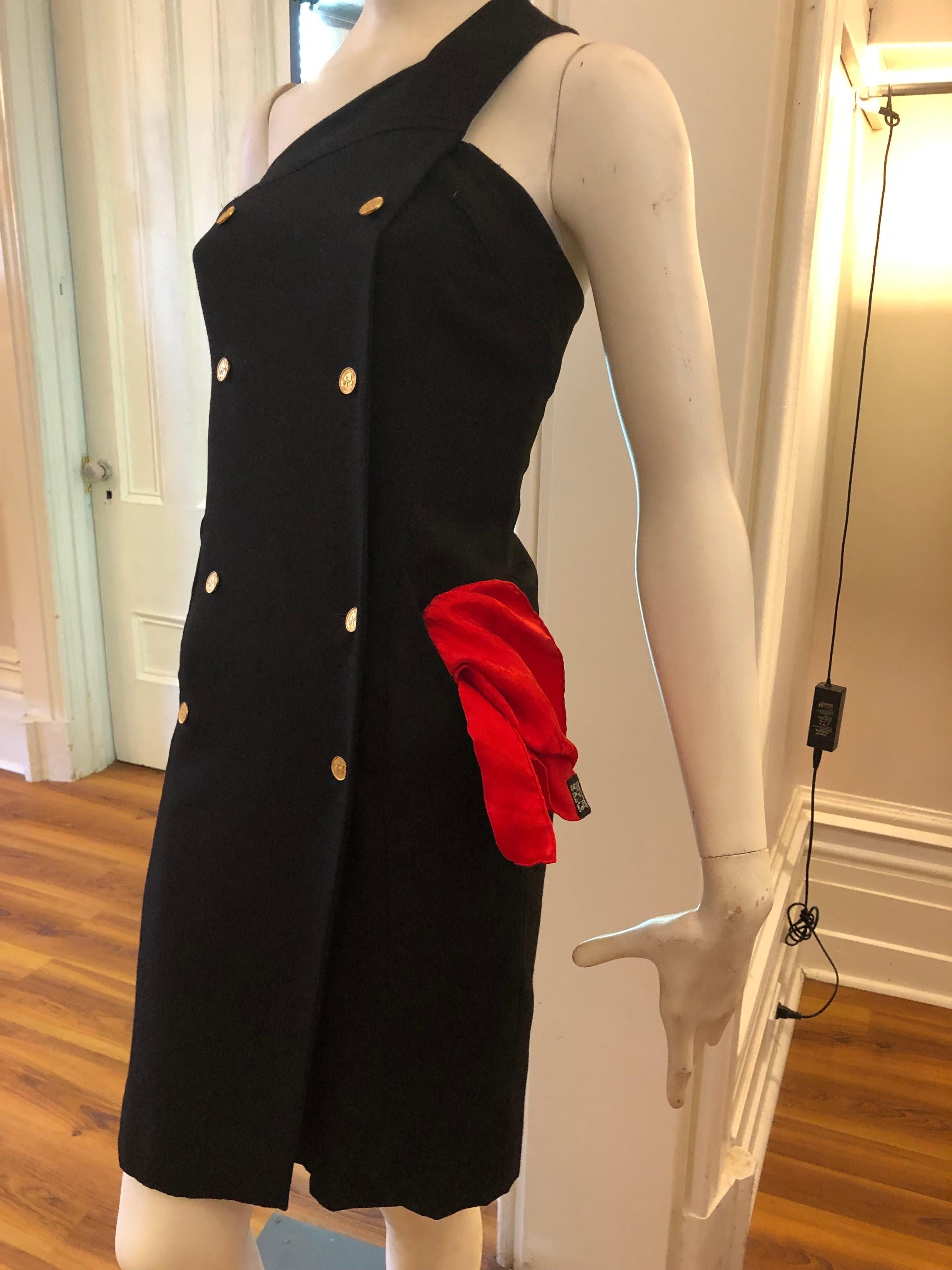 Although a 1980s dress, this black Chanel dress has a very contemporary look. Some of the elements are the one shoulder; two front slit pockets; very fine wool; numerous gold-tone buttons, and double rows of buttons.