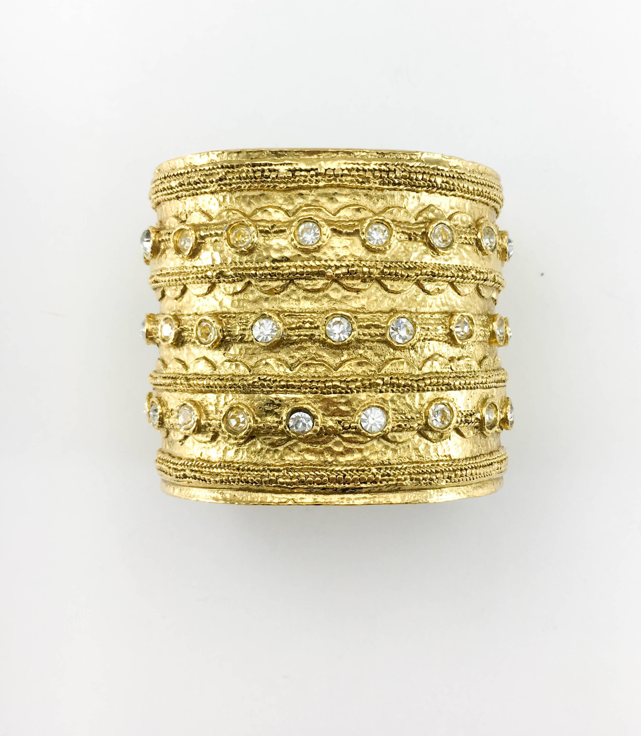 Vintage Chanel Rhinestone Embellished Gold-Plated Cuff Bracelet. This fabulous piece by Chanel dates back from the 1980’s. It is crafted in gold-plated metal and adorned with rhinestones. The beautiful design is inspired by Etruscan jewellery. It