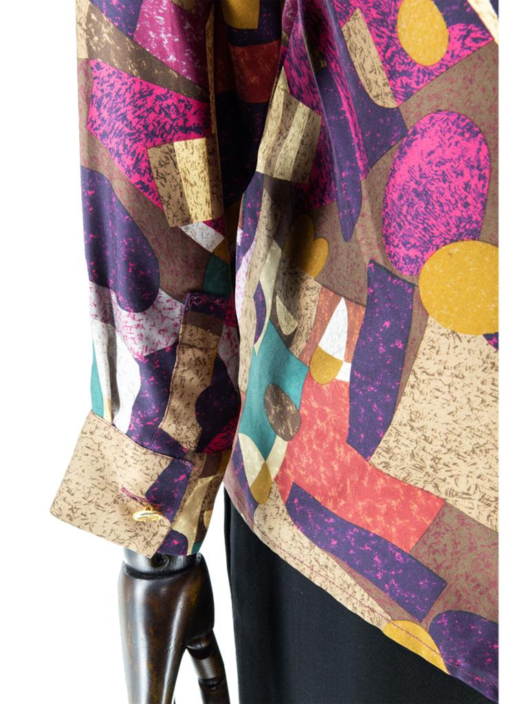 An early 1980’s Chanel Boutique fine silk twill woven long-sleeved top featuring an all-over Kandinski-inspired geometric print in shades of russet-brown, khaki, terracotta, cerise-pink, teal-green, midnight-blue, oatmeal and platinum-grey, with a