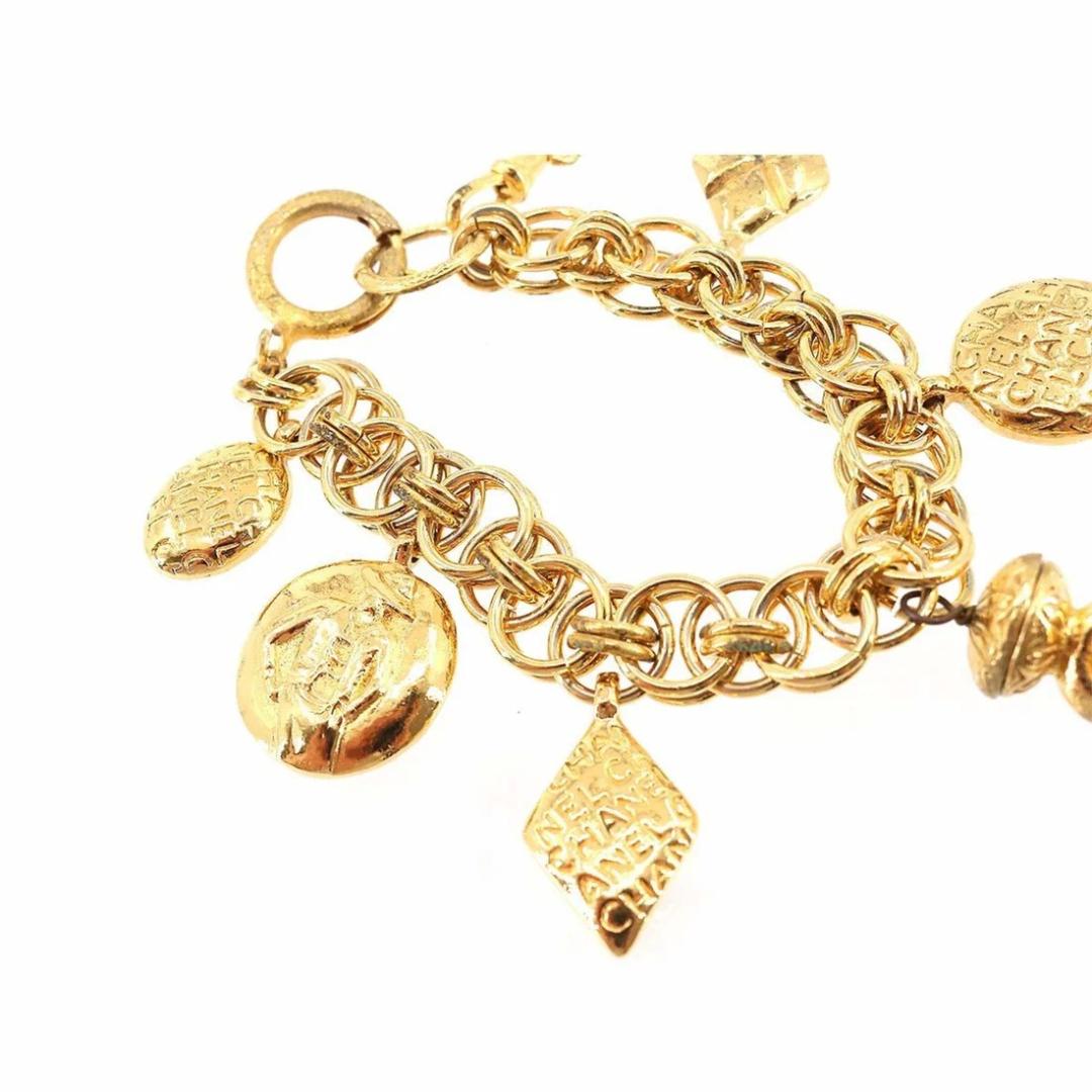 This decadent Chanel bracelet was created between 1980-1983, just prior to Karl Lagerfeld's arrival at the fashion House. Plated with 24 carat gold, seven charms fall from the triple-layered chain of this bracelet. We see two embossed silhouettes of