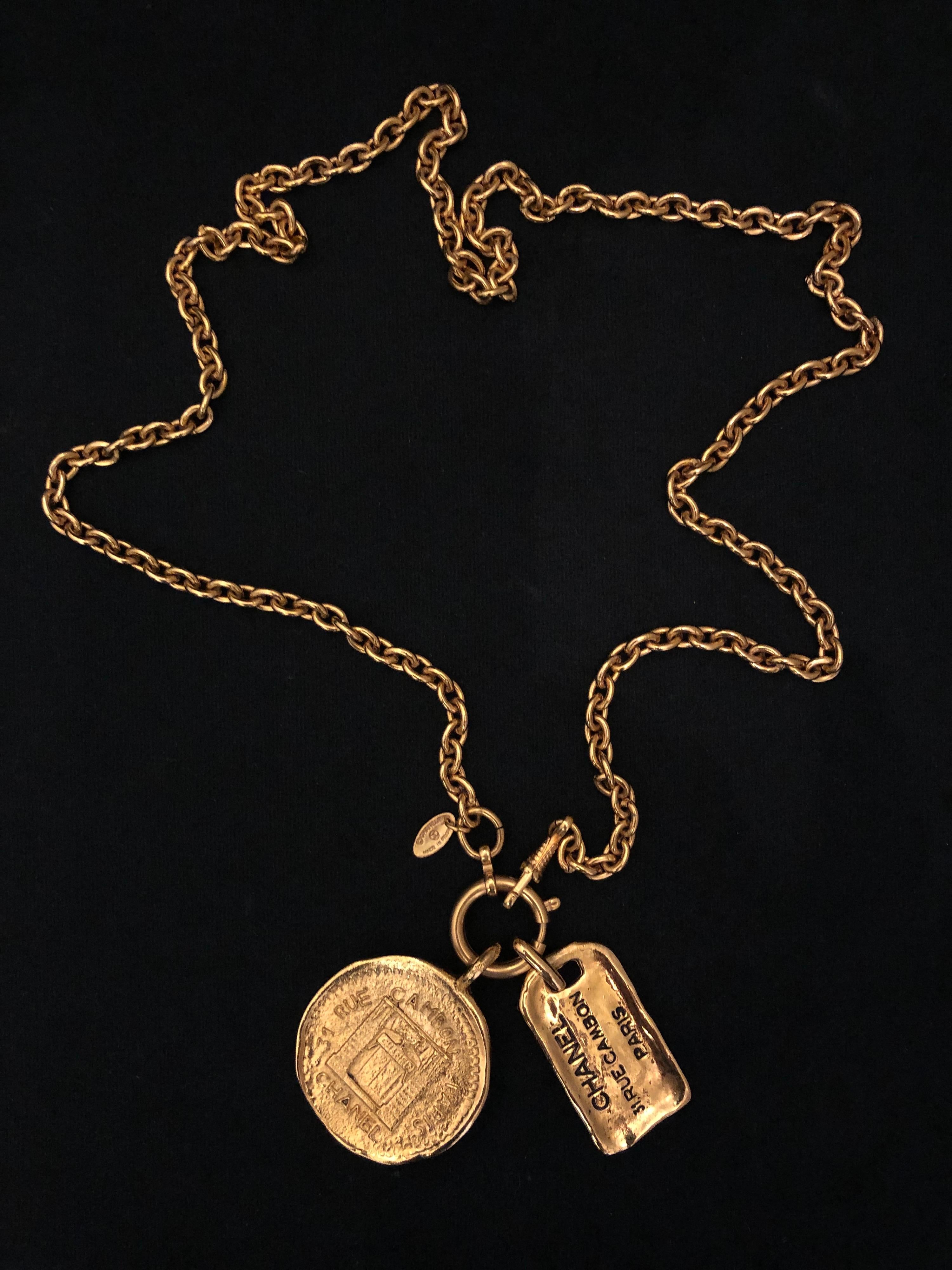 1980s Chanel good toned chain necklace featuring gold toned “31 Rue Cambon” medallion and charm. Spring ring closure. Stamped Chanel made in France. Measures 83 cm medallion 4.1 cm in diameter/4 x 2.4 cm. Comes with box.

Condition - Minor signs of