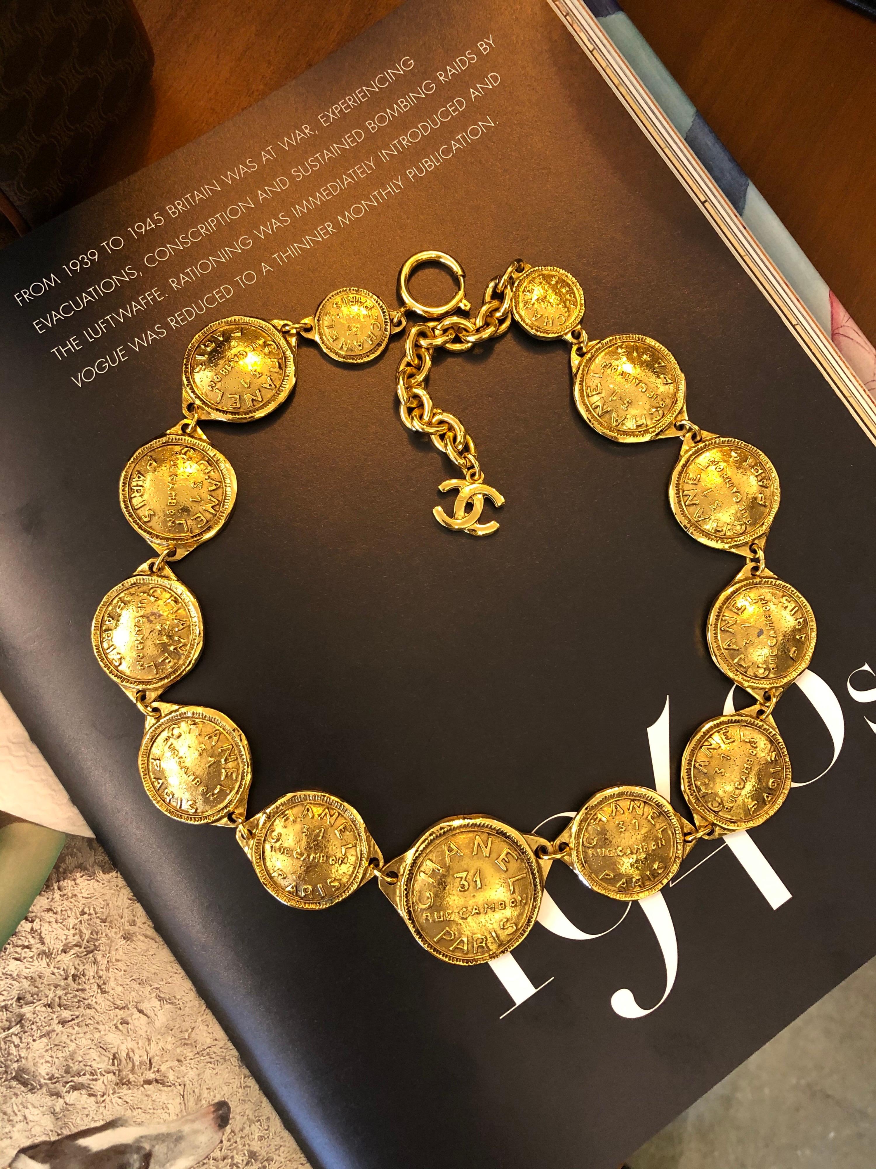 1980s Chanel gold toned necklace featuring 13 gold toned 31 Rue Cambon Paris coins. Measures approximately 56cm Biggest Coin 4.2 x 3.4cm. Stamped Chanel, made in France. 

Condition: Minor signs of wear consistent with age. Generally in good