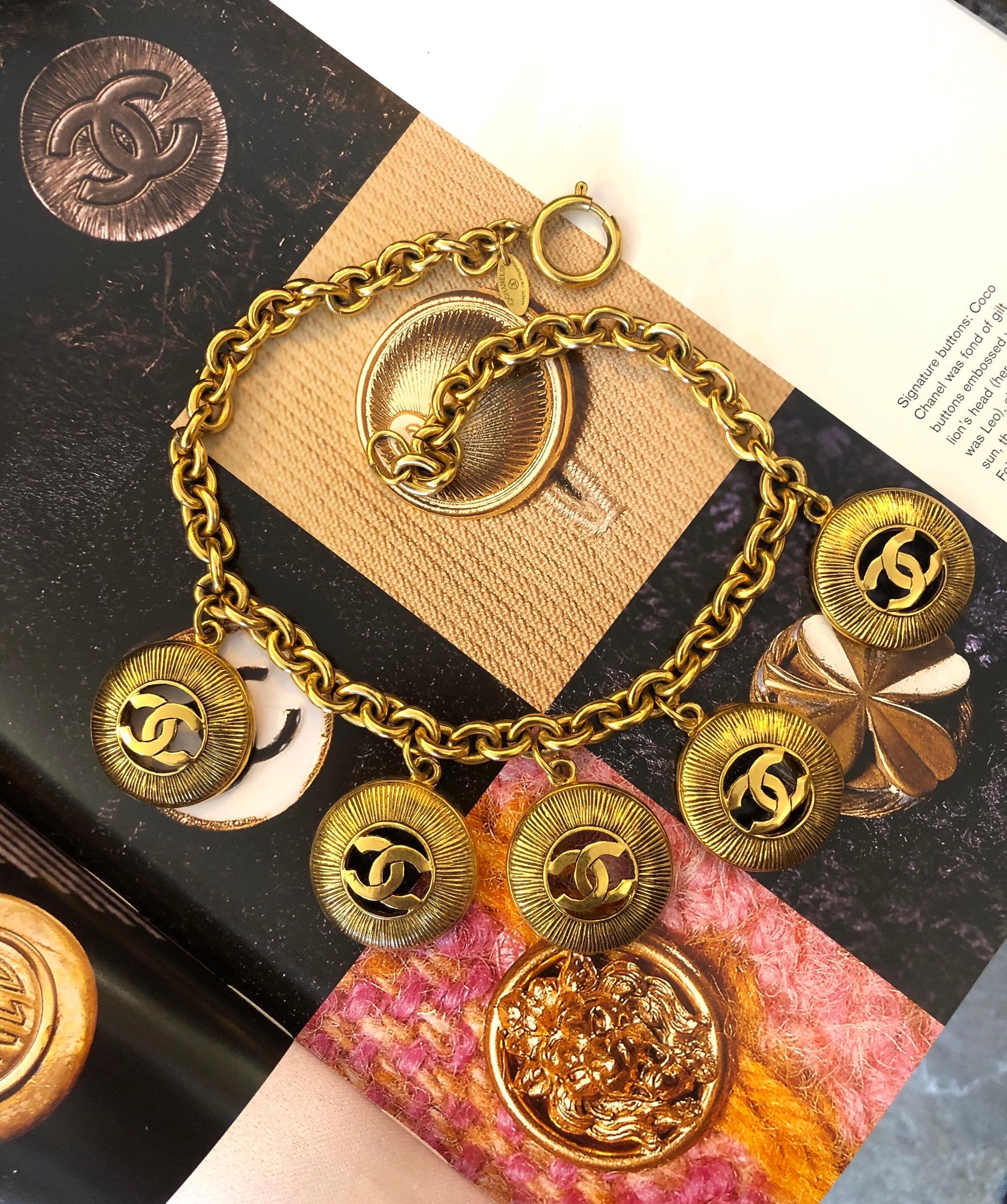 1980s Chanel gold toned chain necklace featuring five gold toned CC coin charms as seen wearing by Kendall Jenner. Stamped Chanel, made in France. Measures approximately 40.5 cm (16 inches). Comes with box. 

Condition: Some signs of wear consistent