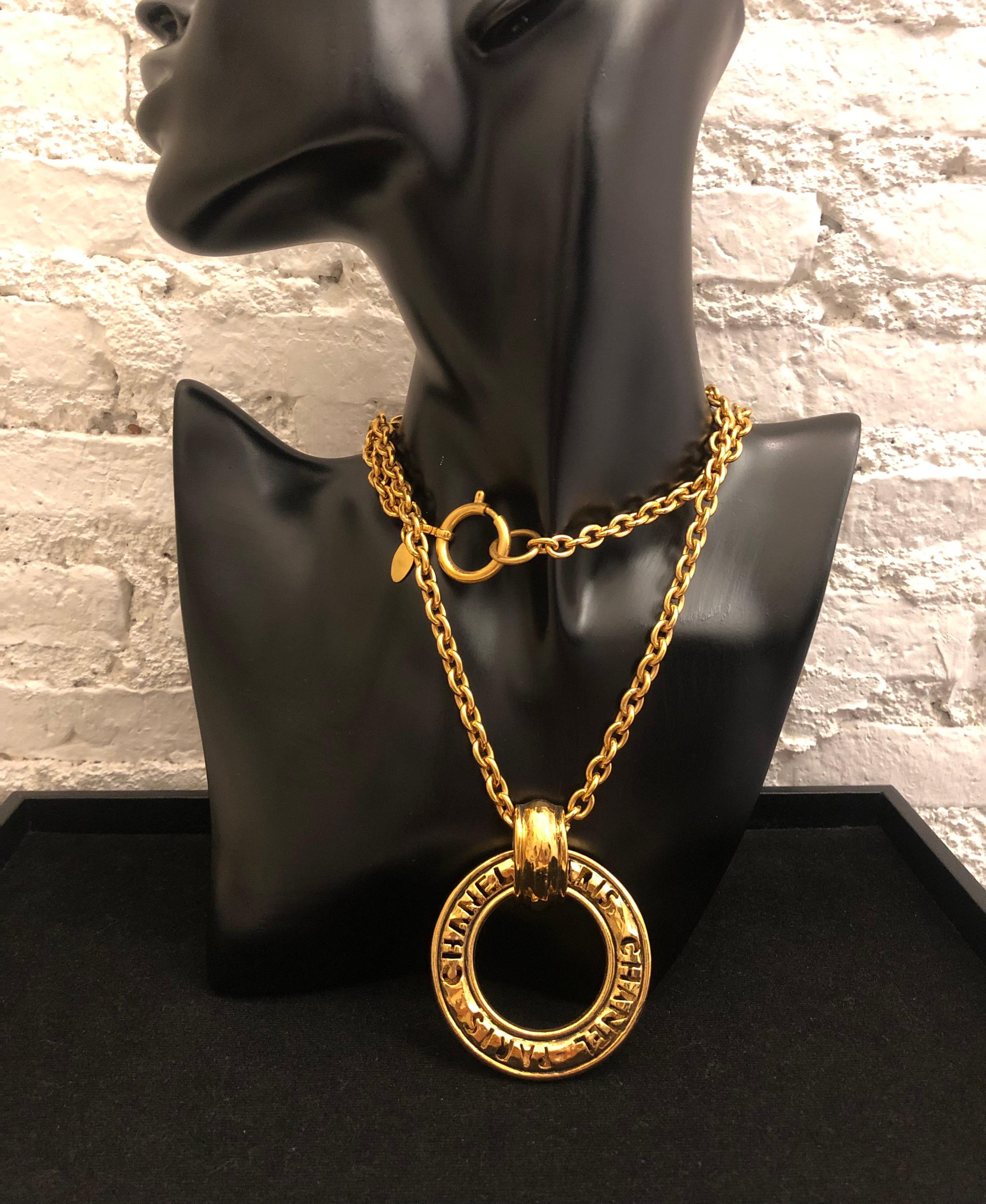 1980s Chanel gold toned chain long necklace featuring a cut-out CHANEL PARIS letter charm. Stamp Chanel made in France. Measures 94 cm Charm 5.3 cm. Spring ring fastening. It can be worn long with single chain or short with double chain. Comes with