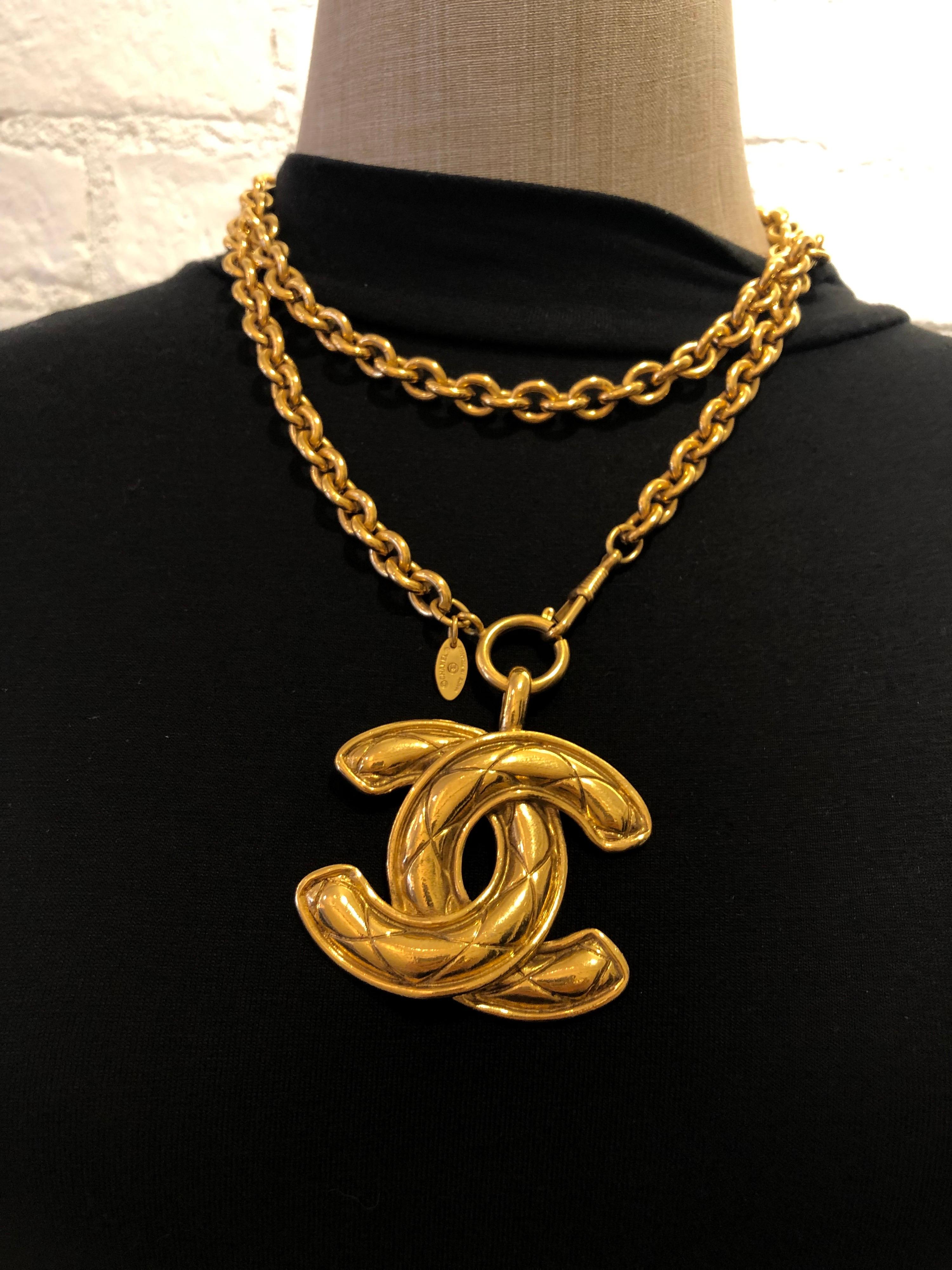 1980s Chanel gold toned chain necklace featuring a huge iconic gold toned Chanel quilted CC charm. The largest of the quilted CC series. It can be worn single chained as a long necklace or double chained as a short necklace. Stamped CHANEL made in