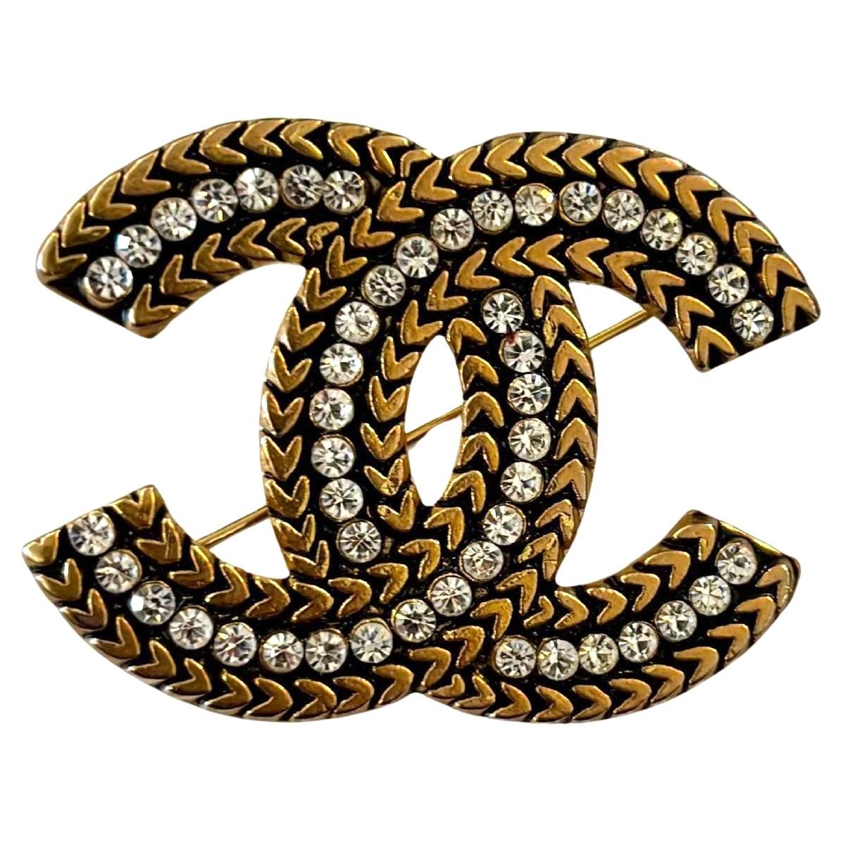 This vintage CHANEL CC brooch is crafted of gold toned metal encrusted with dazzling white rhinestones. Stamped CHANEL made in France. Measures approximately 4.5 x 3.7 cm. Comes with box.

Condition: Excellent vintage condition with minimal to no