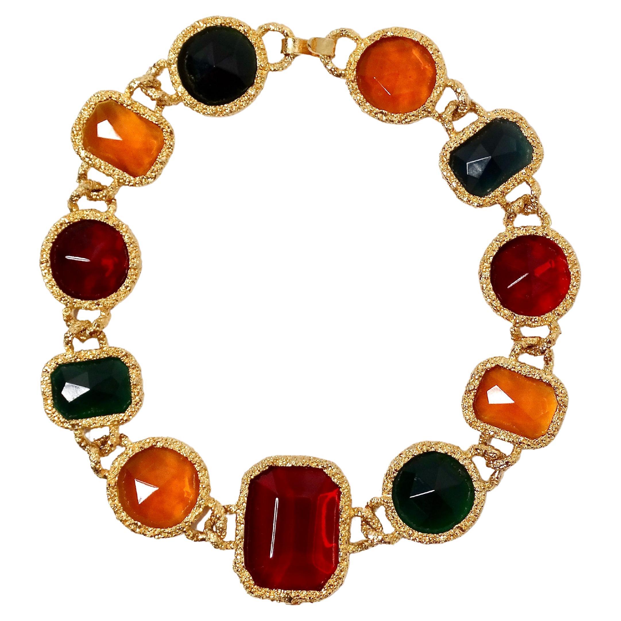 Make a bold statement with this exquisite 1980s Chanel-Like Colorful Jewel-Tone Costume Statement Necklace. Featuring an array of vibrant orangey-yellow, lush green, and deep red faux jewels, this necklace is the perfect accessory for adding a pop
