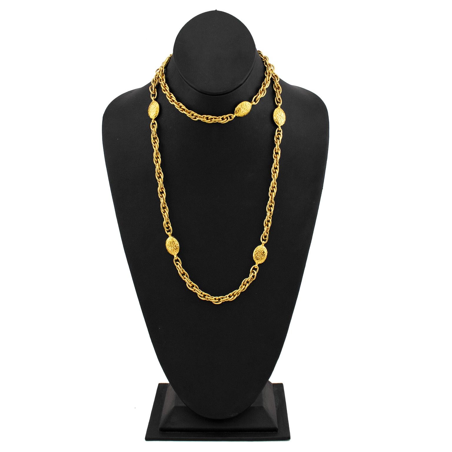 Elegant Chanel gold tone necklace dating from the 1980s. A single long chain with oval shaped links throughout that are engraved all over with CHANEL. The necklace is long enough that it can be looped and worn as a shorter double chain. The perfect,