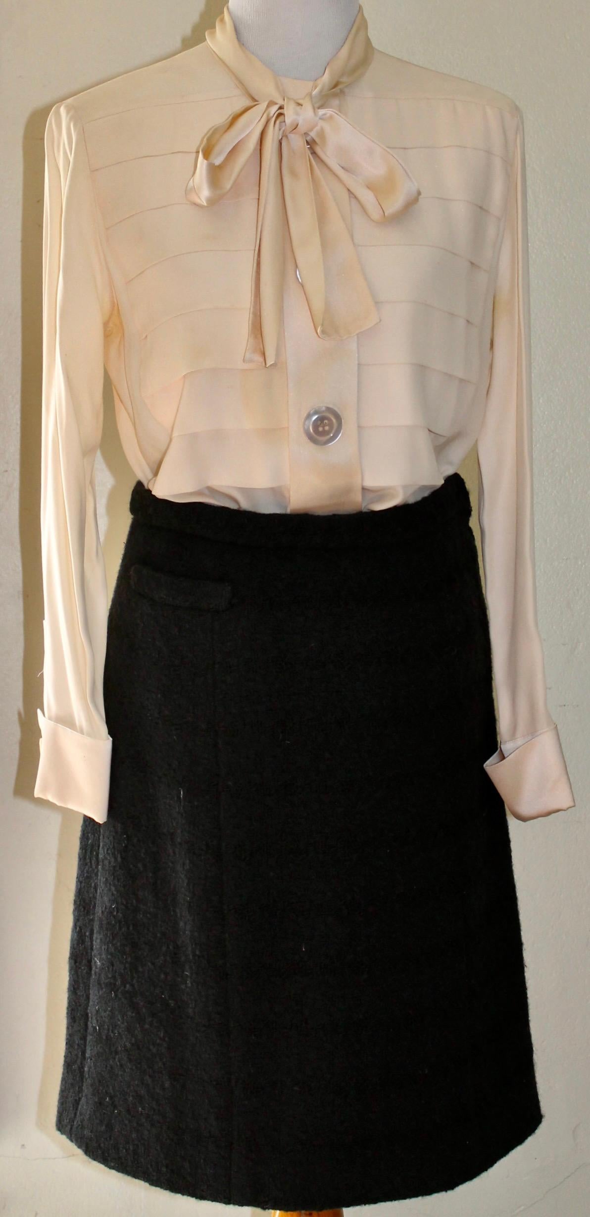 Offering a Silk Blouse and Wool Skirt ensemble. Skirt is 100% thick wool with a horizontal weave, and an all silk lining. Small pocket on right front.
Skirt waist 28