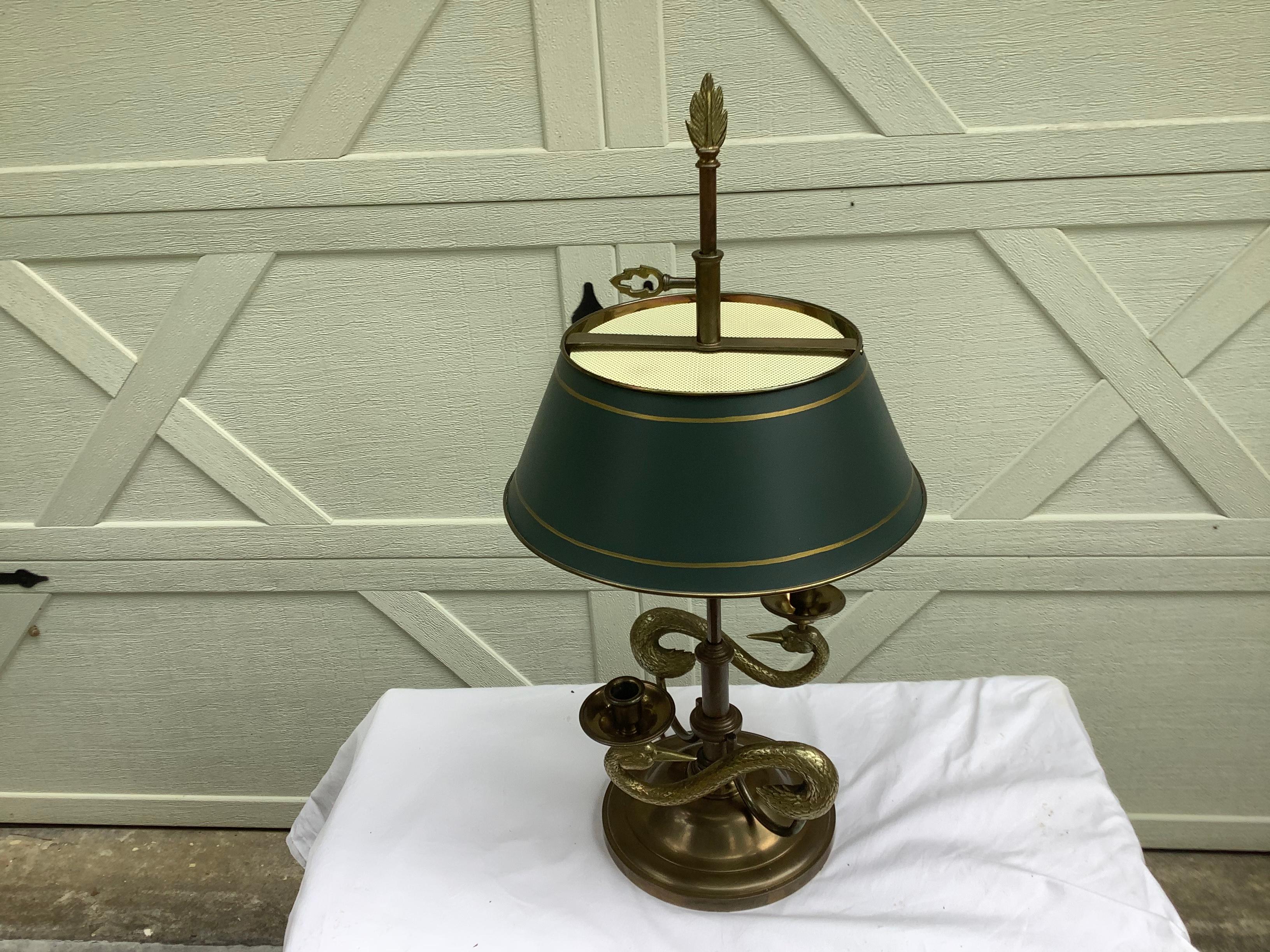 Classic bouillotte style lamp by Chapman, dated 1982. Original patina to the brass, with a green tole shade. The shade does not raise and lower, as an authentic bouilotte lamp. Intertwining swans create the base of the lamp. The measurements are as