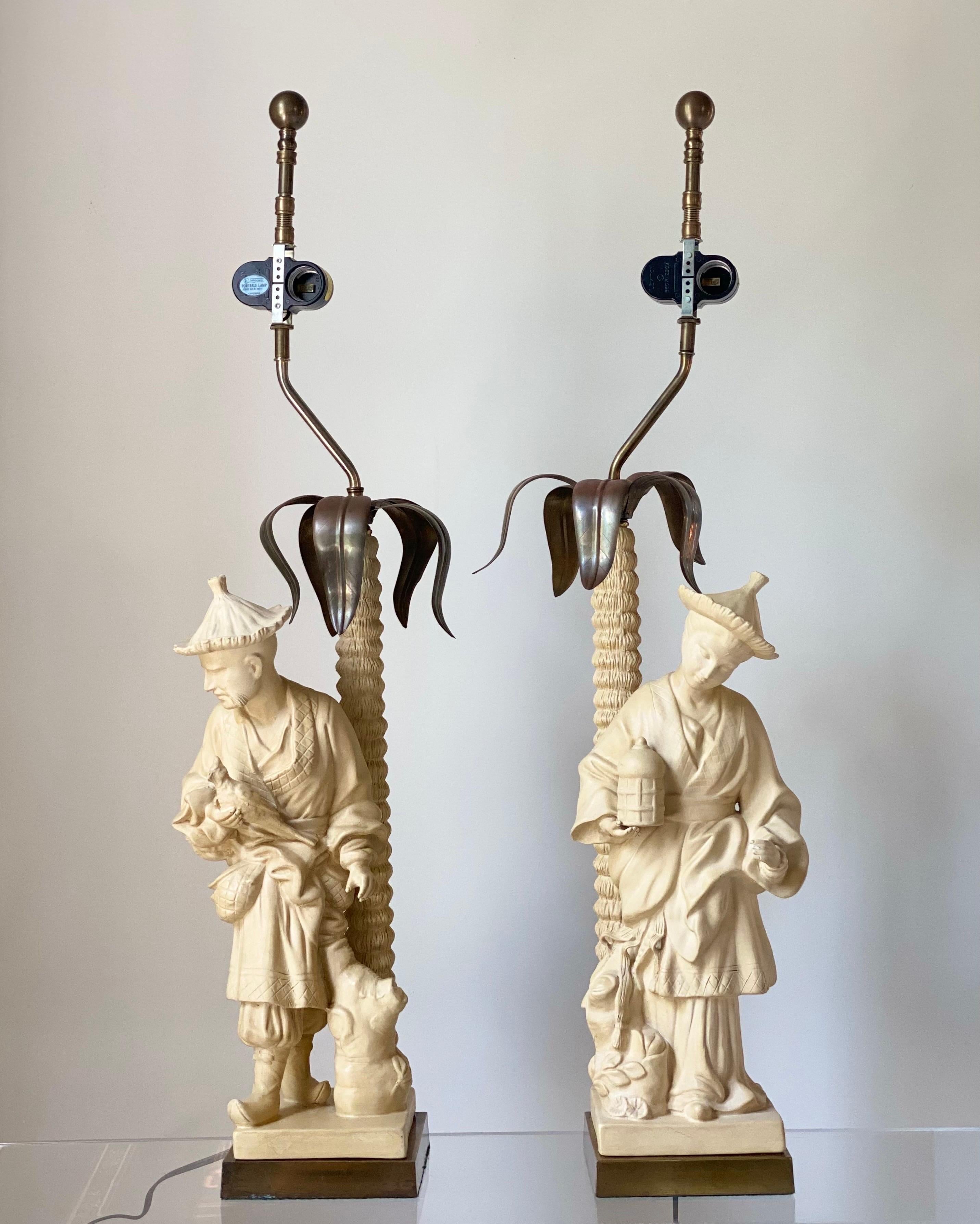 We are very pleased to offer an exquisite pair of sculpted, vintage chinoiserie style table lamps by Chapman, circa the 1980s. Create a beautiful visual in your space with this porcelain pair, full of traditional Asian details. Elongated figurines