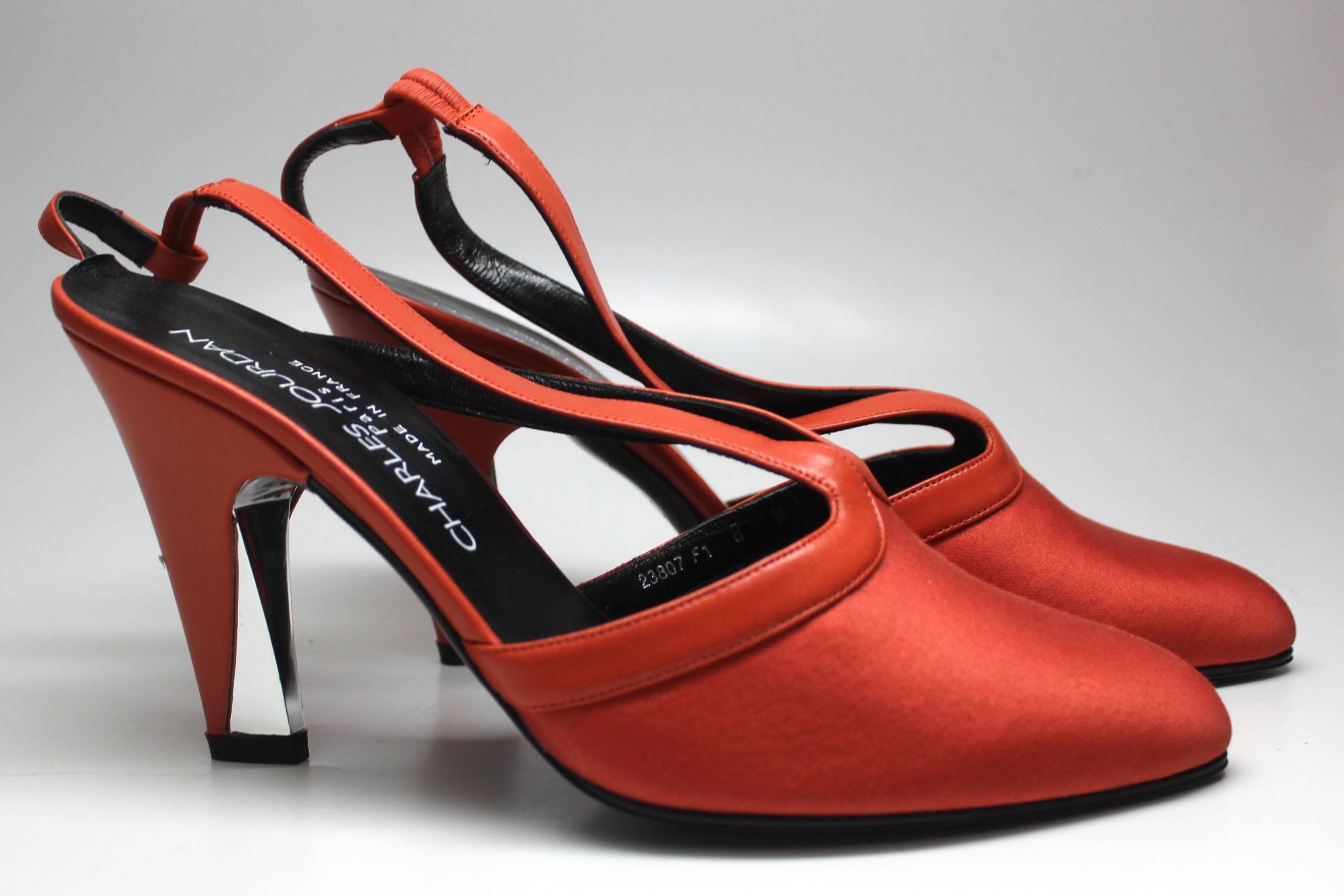 Charles Jourdan Paris - Made in France
Orange leather trims the shoe and slings back to the ankle. The heel is half mirror, half orange leather. The toe is a made from a beautifully complementing red-orange satin. The mix of materials gives a truly