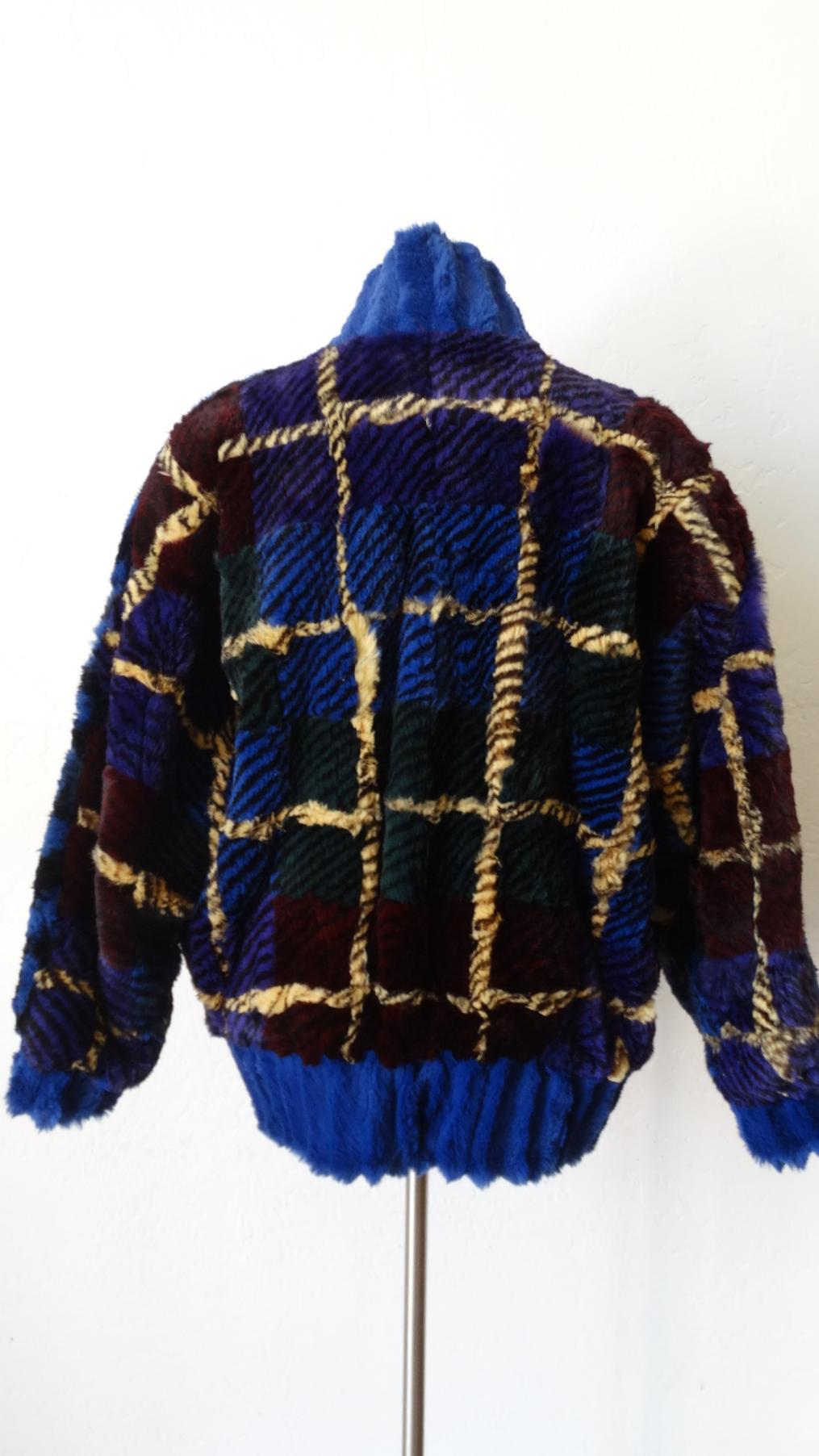 Embrace Your 80s Girl With This Jacket, Circa 1980s, this sheered rabbit fur bomber jacket features a ribbed blue trim on the high standing collar, cuffs and hem. Includes a an overall tiger print made up of deep purple, burgundy, green and blue.