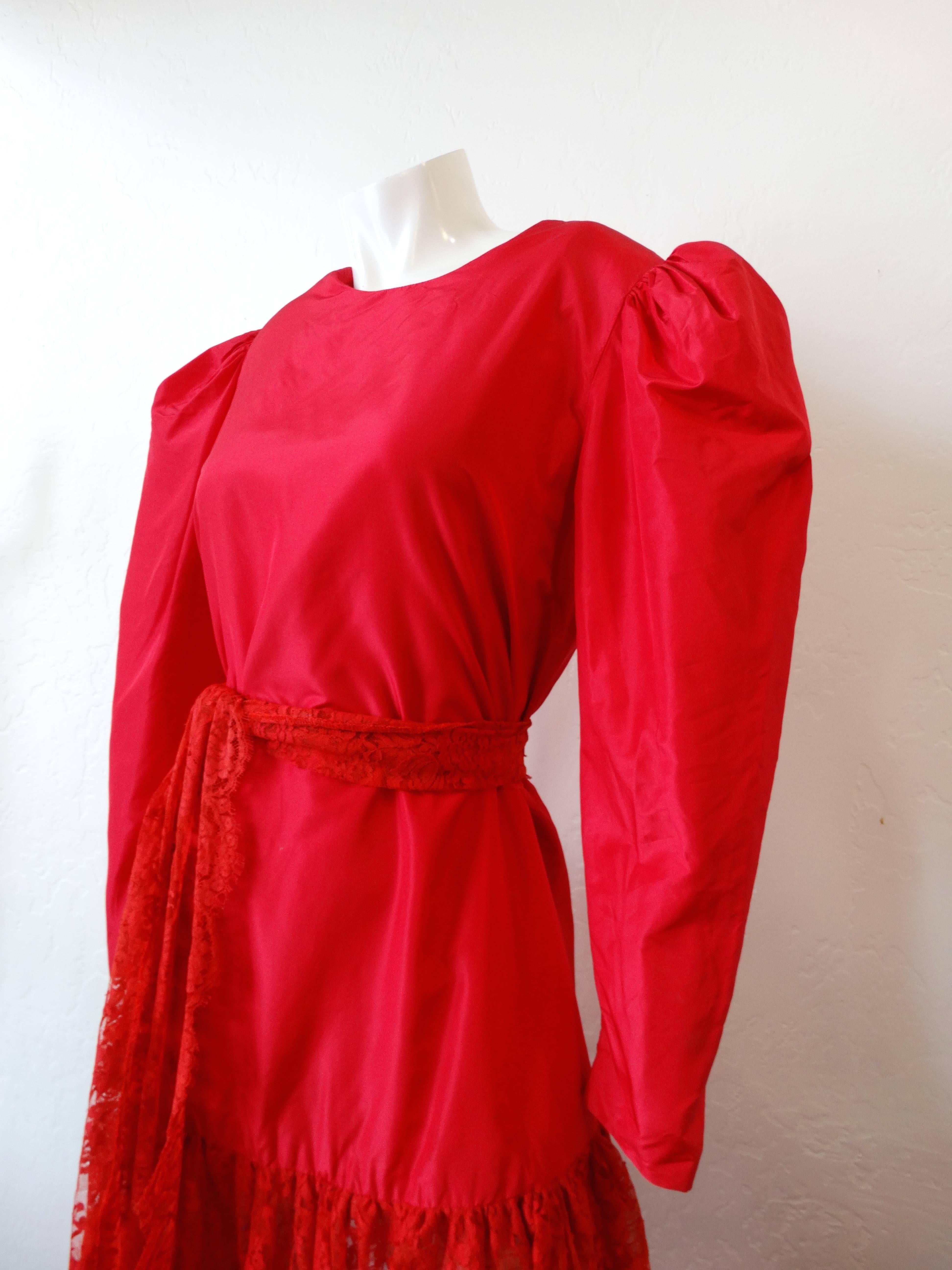 Channel your inner Kate Bush and rock a dramatic red dress! This adorable lace dress is SO-1980s in all the right ways! Bold, sculptural sleeves demand your attention- not to mention the bright cherry red color! Skirt is made of a matching intricate