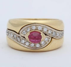 1980s Chic Cabochon Ruby with Diamond Swirl Design Gold Band Style Ring
