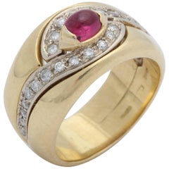 1980s Chic Cabochon Ruby with Diamond Swirl Design Gold Band Style Ring