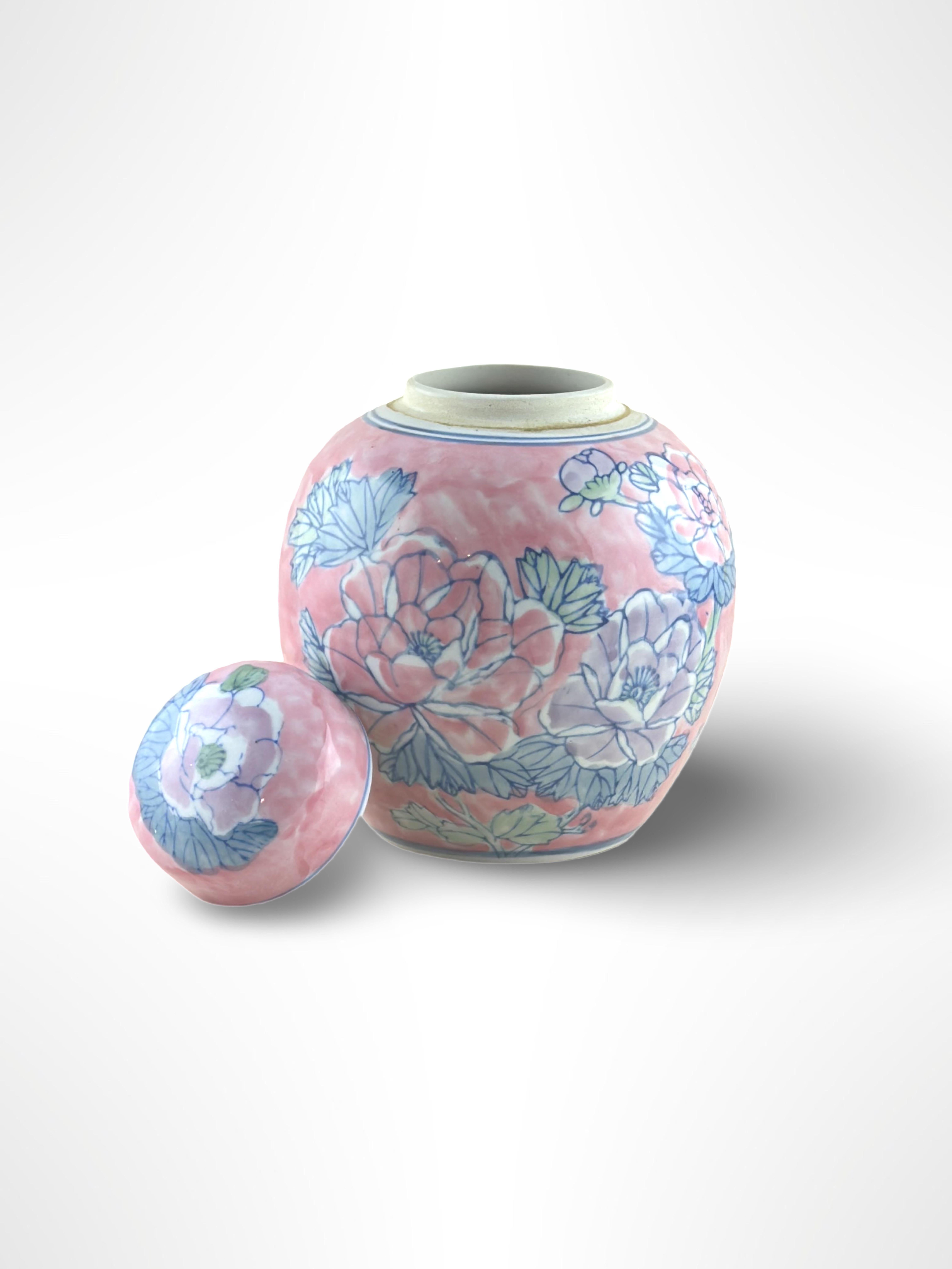 Chinese pink ginger jar.  Crafted in China in the 1980s

A bold and modern iteration of the classic styles of Chinese ginger jars. Decorated with large stylised peony flowers, coloured in lavender and pink hues and accented with cool mint green