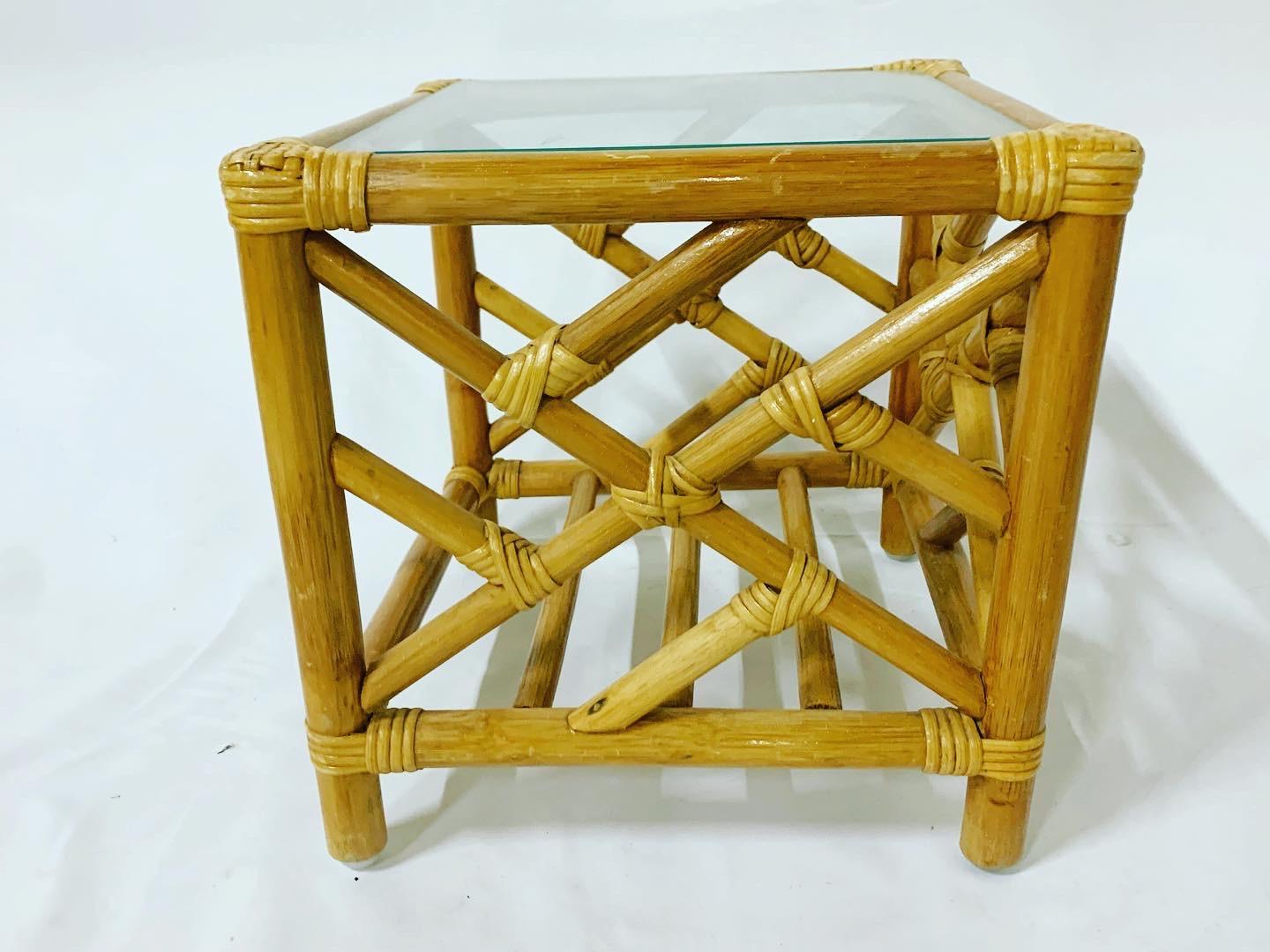 Bamboo rattan nesting tables with Chinese chippendale design and glass tops. These are three tables in total which nest perfect within each other.
Largest table measures: 22”x22” with a height of 21”
Middle table: 17”x17” with a height of