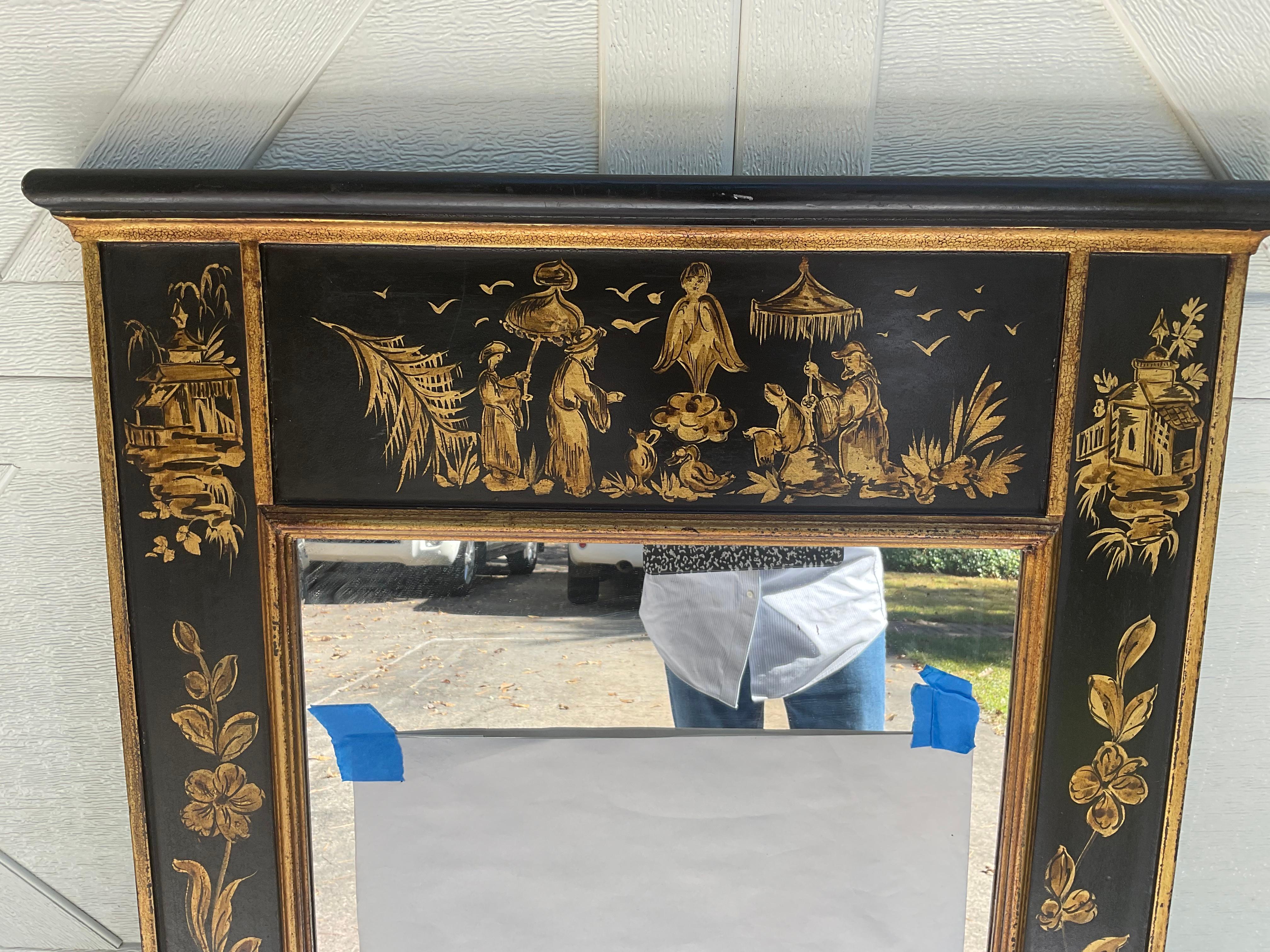 Lovely, hand painted mirror with Chinoiserie figures and scenes. Black background with gold accents. Most likely Italian, and attributed to LaBarge. The mirror itself, measures 34.75” x 17”.