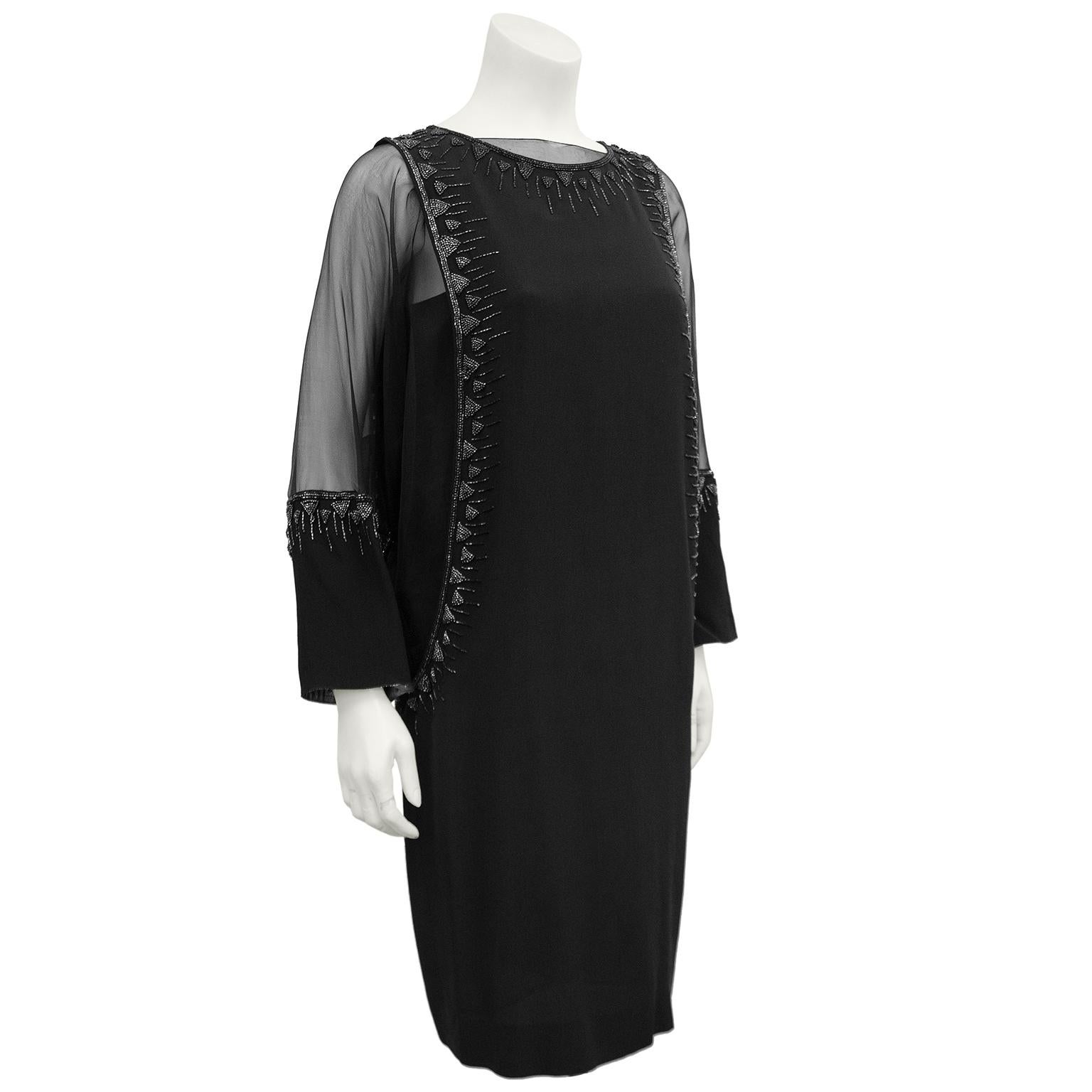 Not your average LBD. 1980s cocktail/black tie dress Inspired by the layered evening dressing of the 1920s. Stunning 3 piece black hand beaded creation . Features a black slip, under a sheer long sleeve black shift with dolman sleeves, pewter beaded