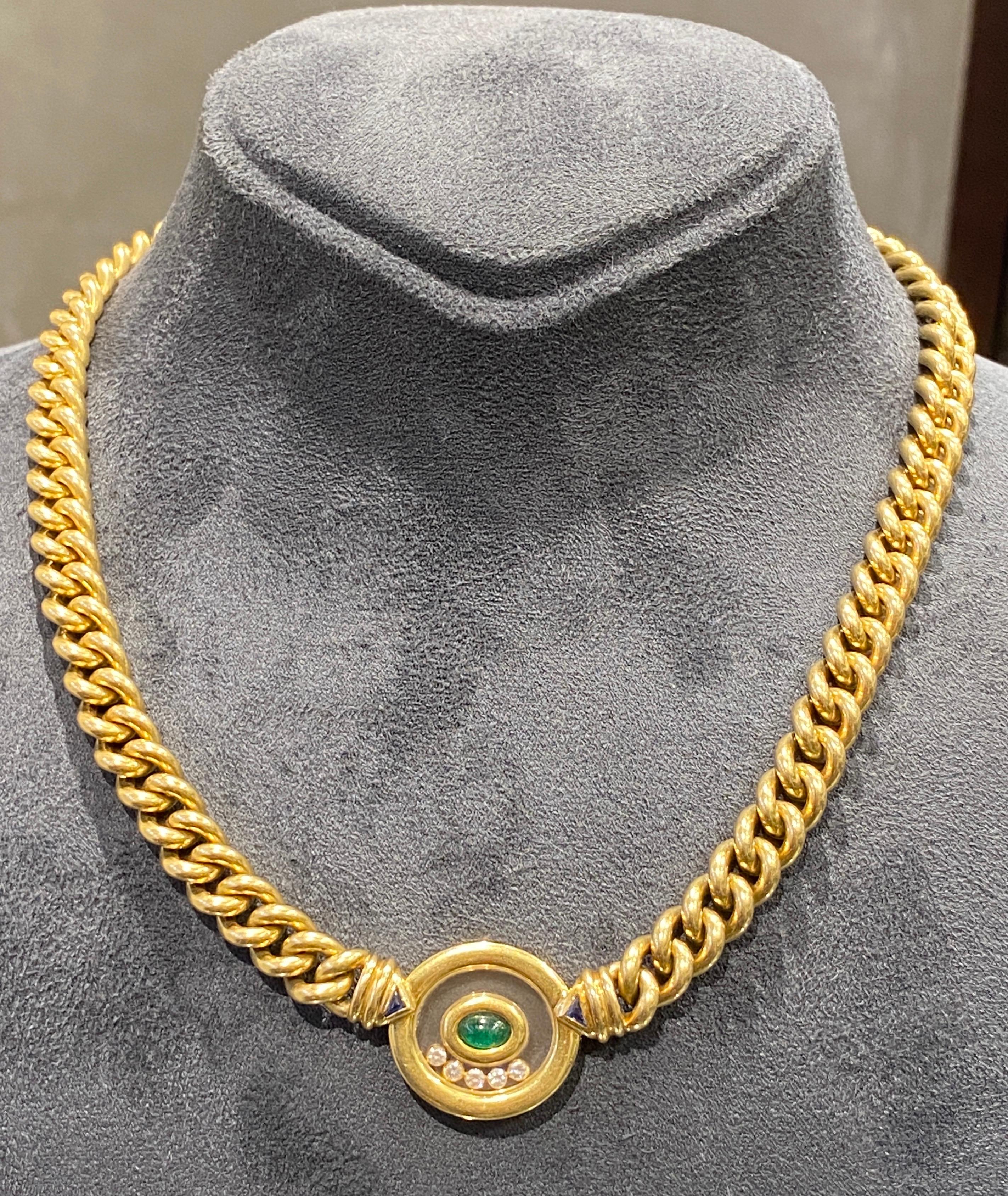 This 1980s Chopard hefty 18 carat gold chain necklace is adorned with a cabochon emerald, 2 small sapphires and 5 happy diamonds.