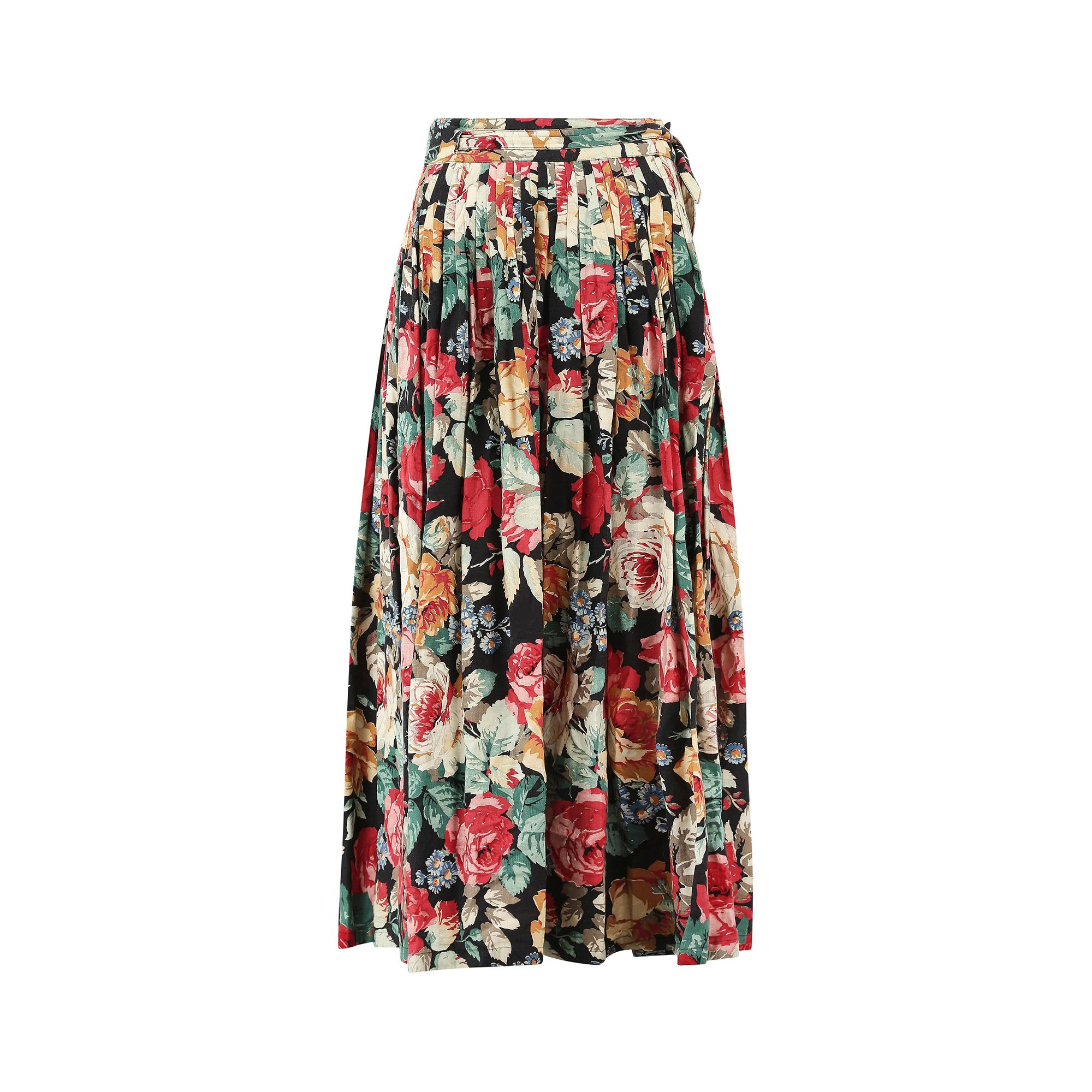This early 1980s Christian Aujard skirt is constructed from a thick, high quality cotton fabric in a classic wrap over style silhouette. It is pleated on either side of the hip which creates a lovely flowing effect all the way down to the hem. Due