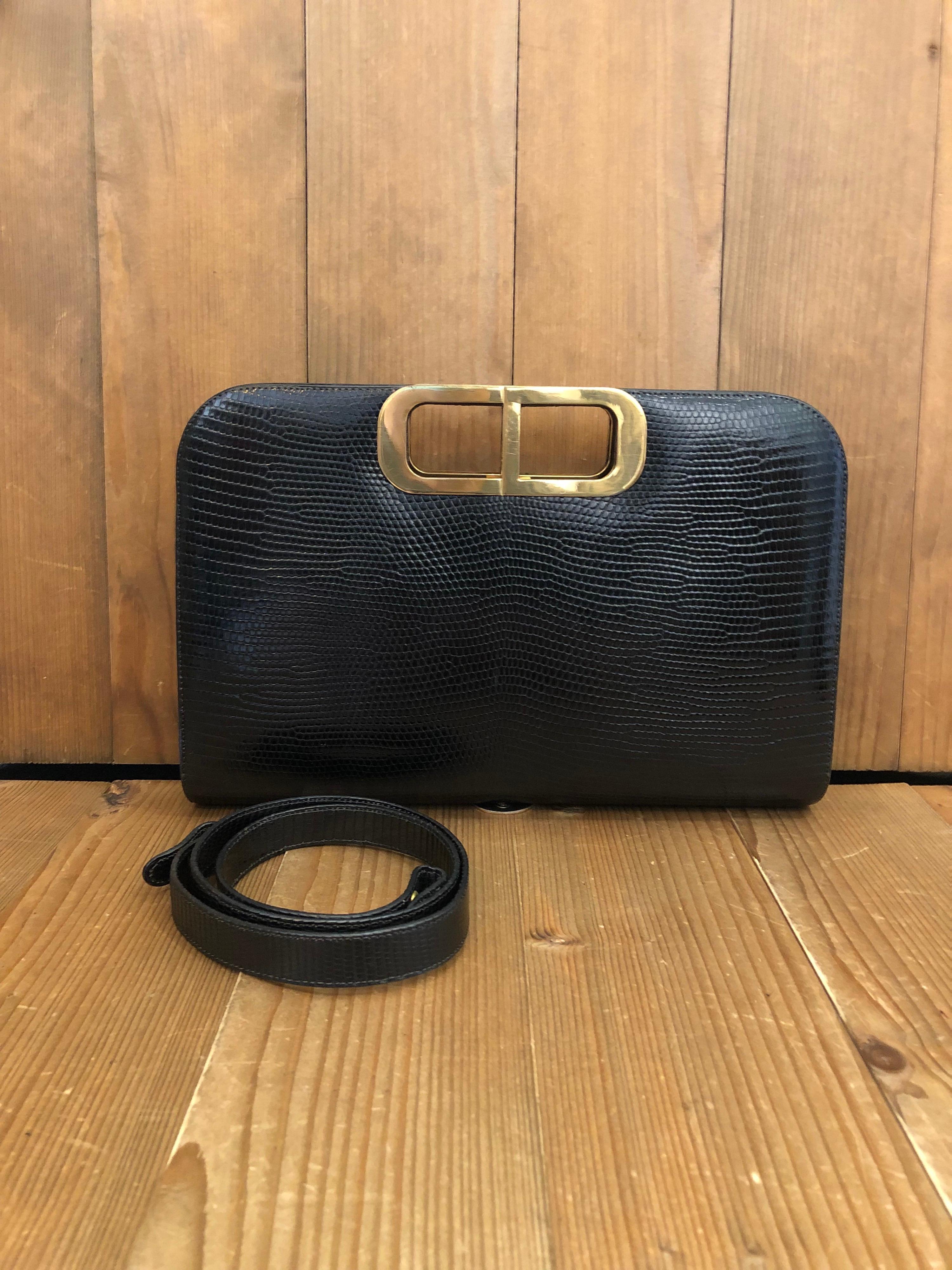 Vintage Christian Dior Two Way Clutch Shoulder Bag in black lizard skin featuring gold toned CD handles. Comes with detachable strap to carry it as a shoulder bag. Made in France. Measures 11 x 7 x 1.5 inches.

Condition: Some signs of use