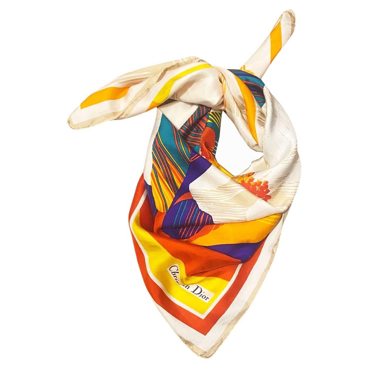 Vintage hand rolled edge silk scarf by Christian Dior featuring cream with abstract leaves in jewel colors of scarlet/orange/emerald & purple This piece ofstatement jewelry will offer a timeless touch to any outfit, with a vintage style that stands