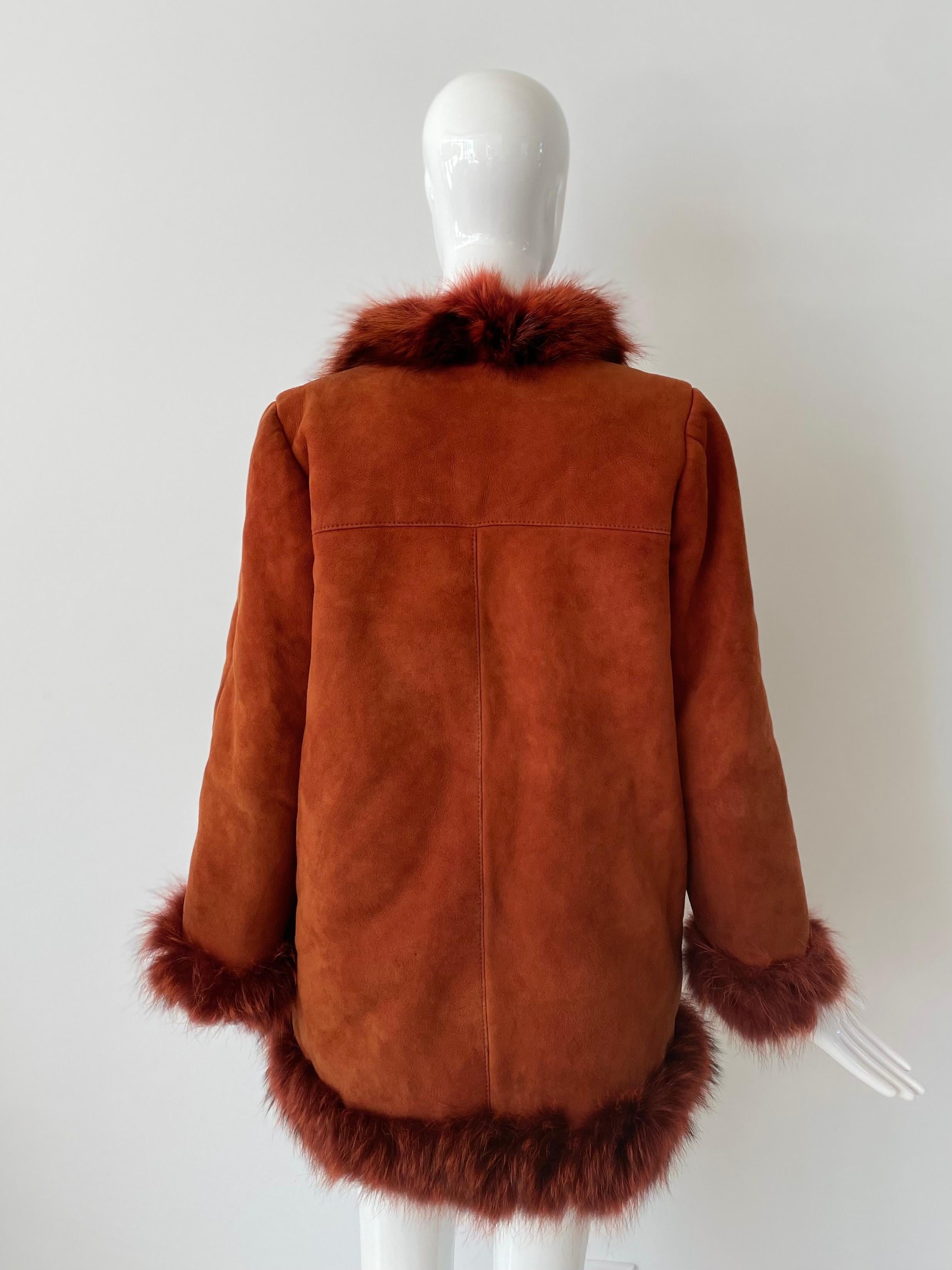 1980s (or early 90s) Christian Dior Fourrers stunning tomato red suede coat with red shearling lining and red dyed fox fur trim along the collar and cuffs. Leather geometric shapes applied on the left shoulder area and right hip.  Two side hidden
