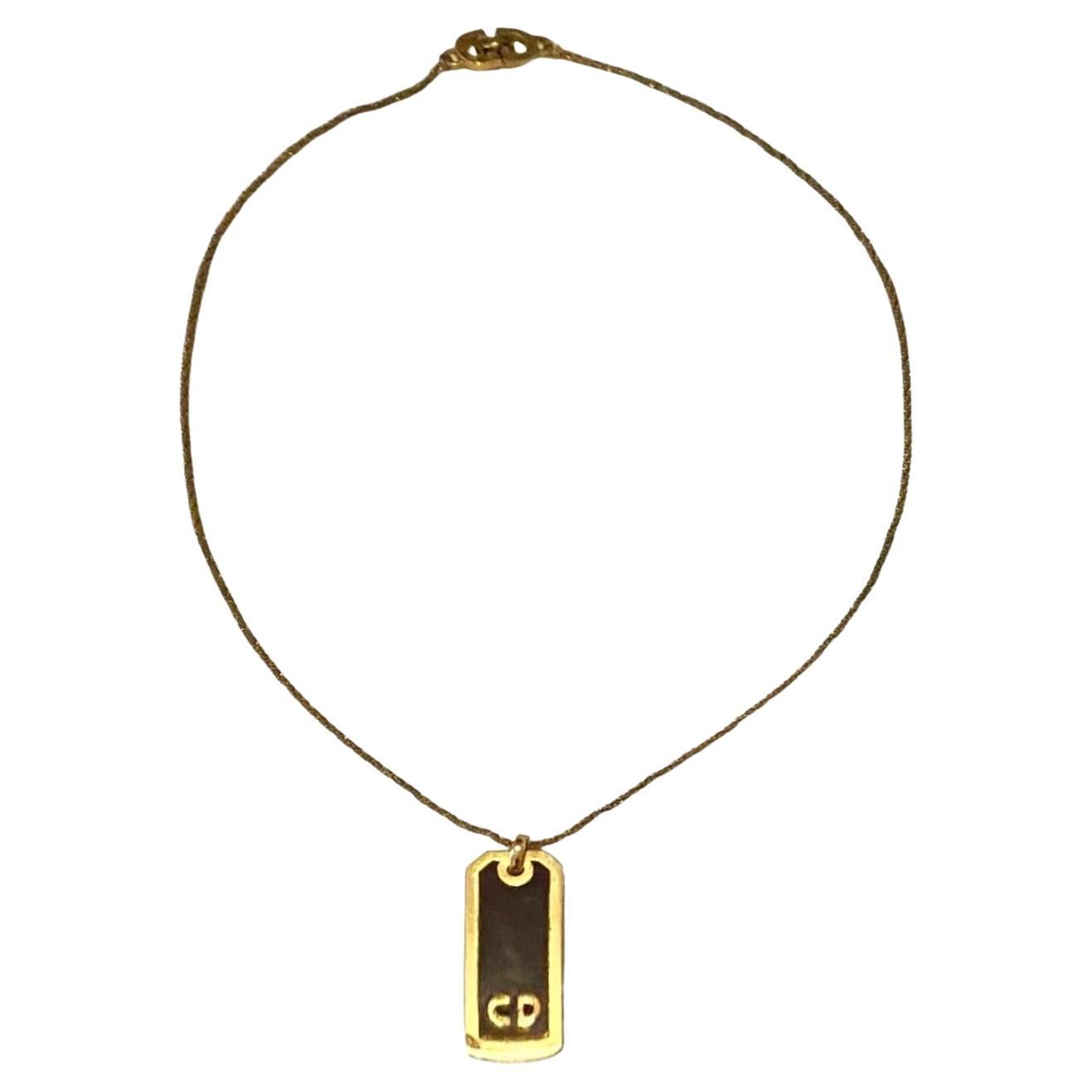 Stylish 1980s Christian Dior Logo Plaque Pendant Necklace, featuring a vertical plaque enameled pendant adorned with the iconic CD logo, crafted and marked with 