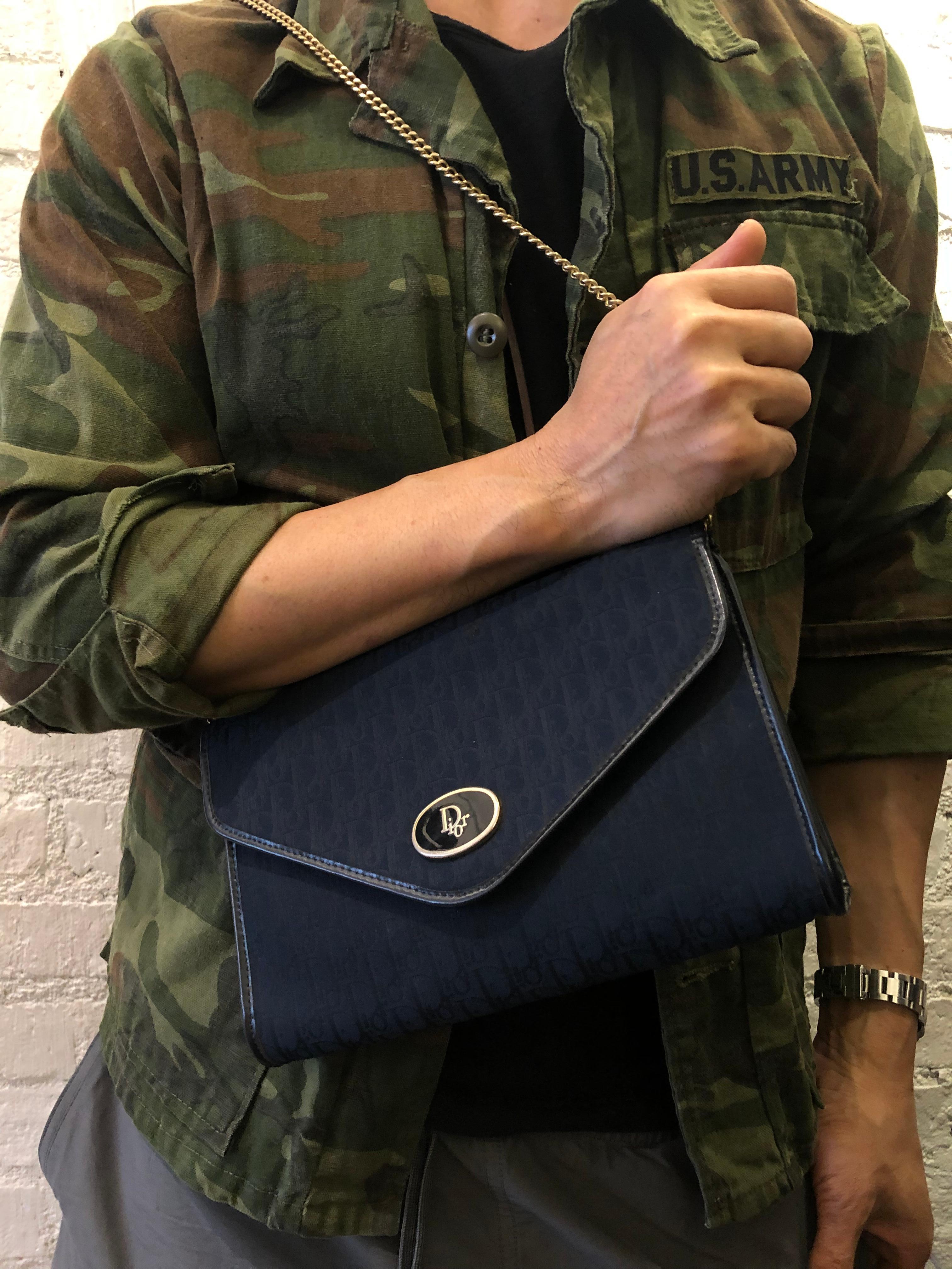 This vintage Christian Dior chain shoulder bag is crafted of Dior’s navy trotter jacquard. Adjustable single or double chained. New magnetic closure opens to a navy coated interior. Made in France. Measures approximately 9.75 x 6.5 x 1.5 inches