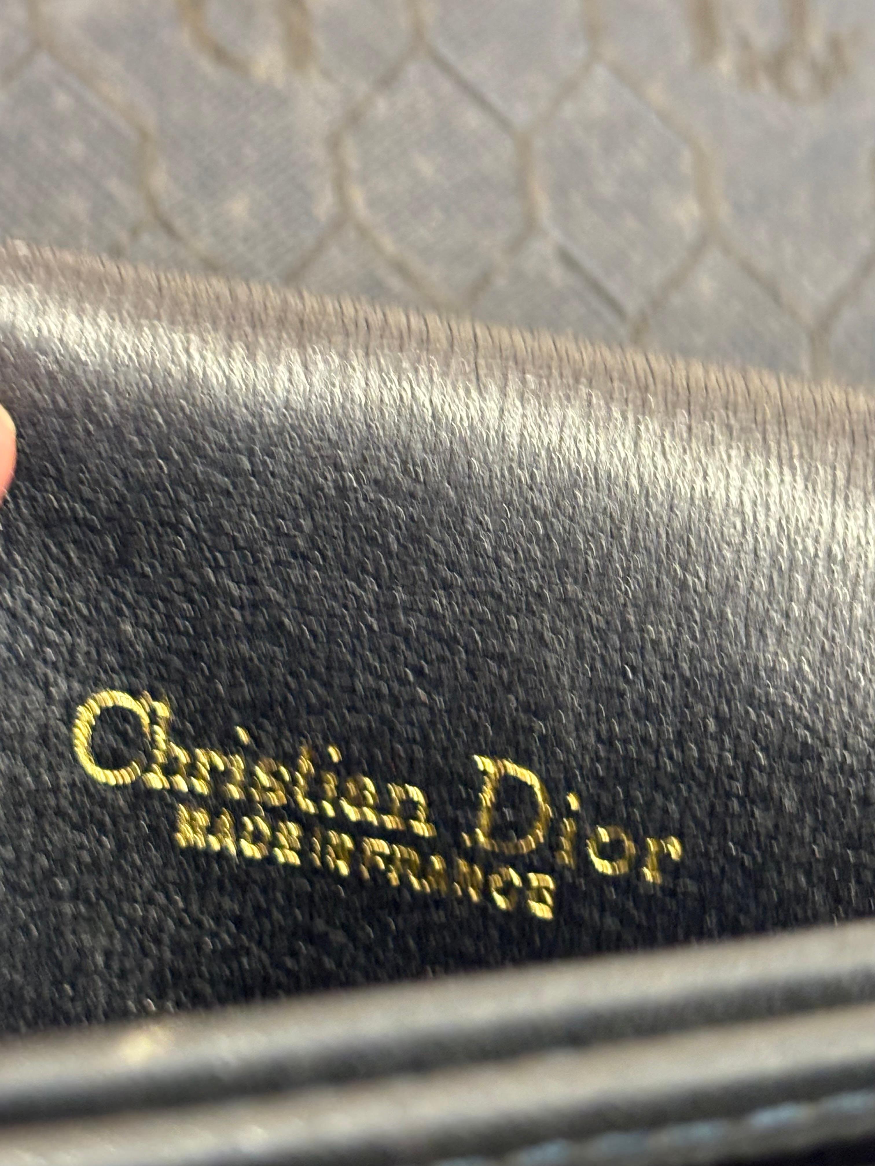 This Christian Dior Honeycomb B Canvas Leather Saddle Crossbody Bag is rare and from the 1980s.
The canvas body has  an alternating honeycomb and Dior pattern.
There are three large slot compartments and one middle smaller one on the inside.
You