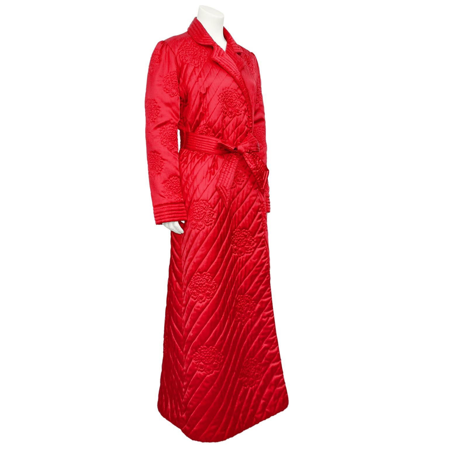Fabulous Christian Dior red lounge robe from the 1980s. Diagonally quilted with large quilted lotus flowers and ribbed cuffs. Matching tie belt at waist. Perfect to celebrate the Lunar New Year! Excellent vintage condition. Made in Hong Kong. 100%