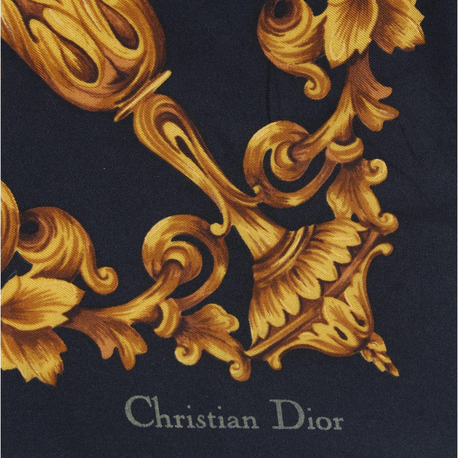 The Christian Dior black silk foulard is embellished by the autumnal inspiration print with colored bordeaux , brown and red fruits and green leaves and elegant golden vases. The brand signature is near the right edge.

Made in Italy
87 cm x 87 cm