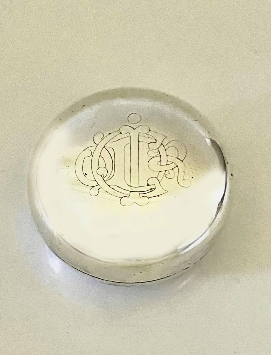 A treasure for collectors, Christian Dior Silver bauble trinket box adorned with the cartouche of the Dior insignia on the top, bearing the Christian Dior mark at bottom and stamped with the makers mark.

Condition: 1980s, vintage, shows light of