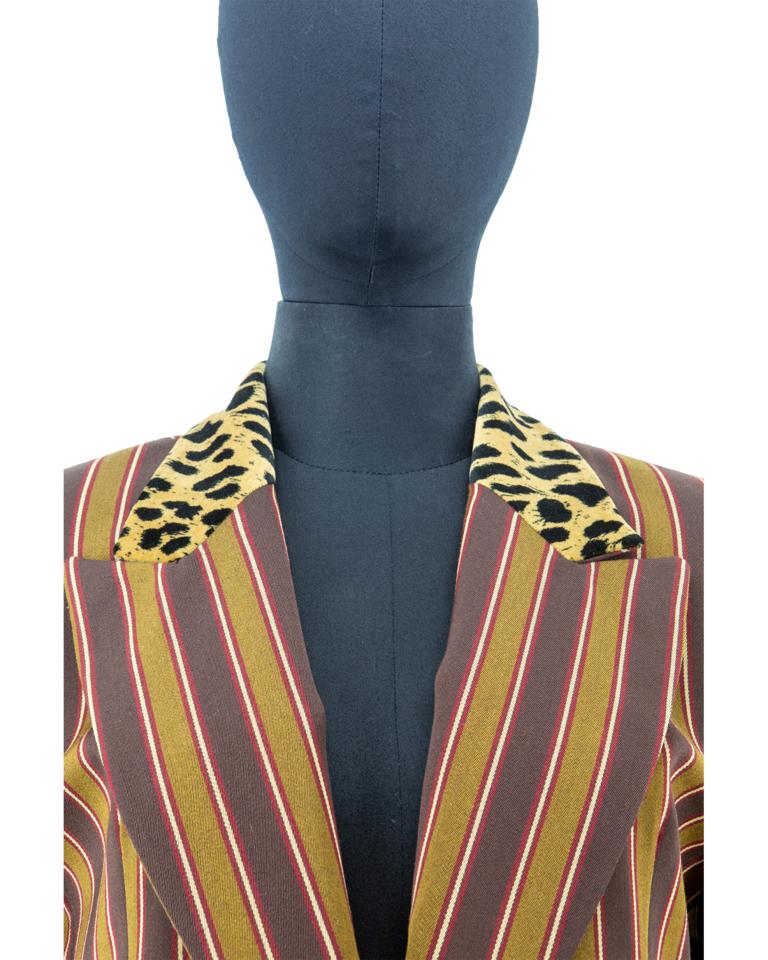 A late 1980’s Christian Dior elongated wool twill woven fitted jacket in an alternating vertical band design in shades of bistre- and coffee-brown, interspersed with maroon and ecru fine stripes, featuring a beige and black leopard print velvet