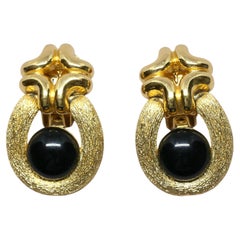 1980's CHRISTIAN DIOR textured gilt earrings with black cabochons