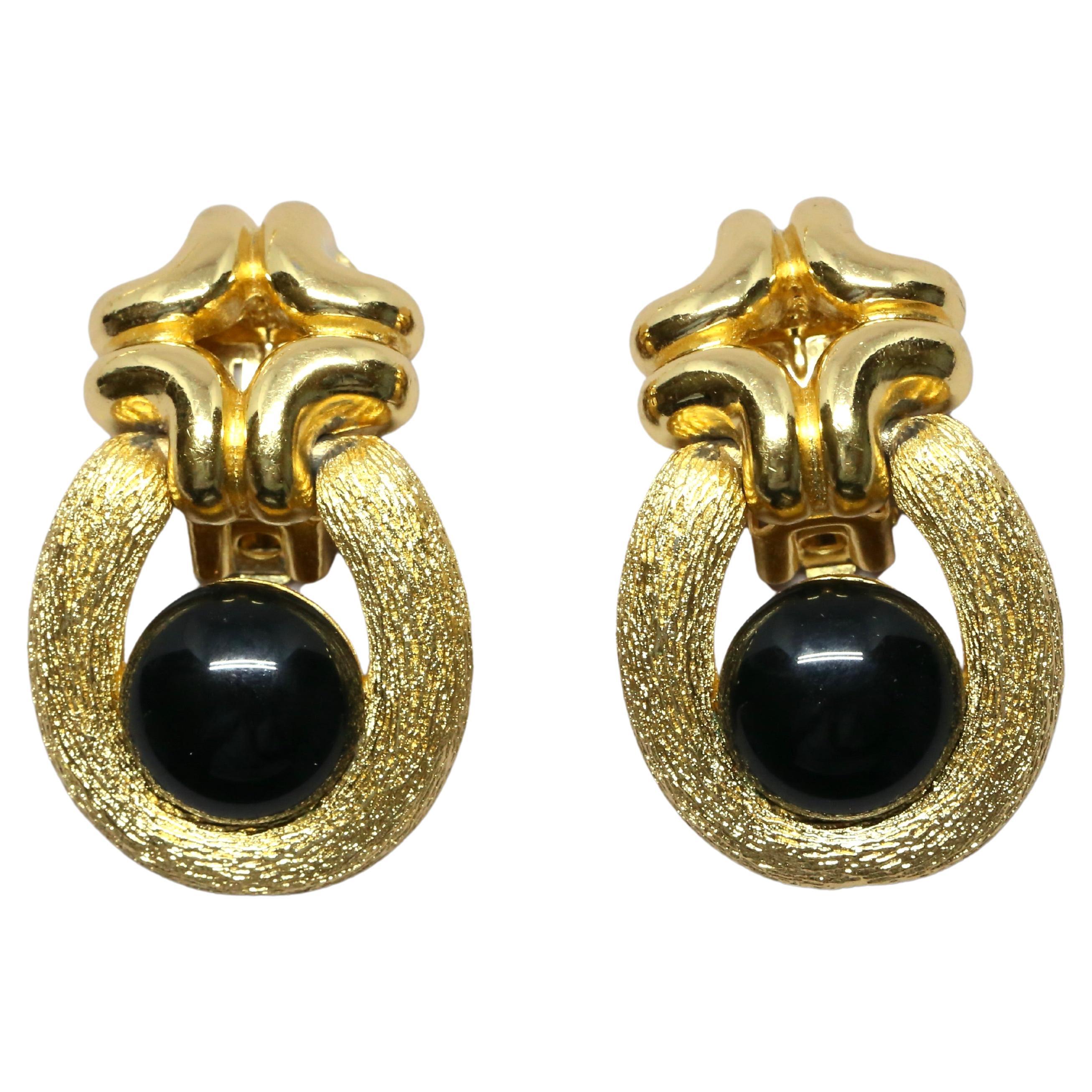 1980's CHRISTIAN DIOR textured gilt earrings with black cabochons For Sale