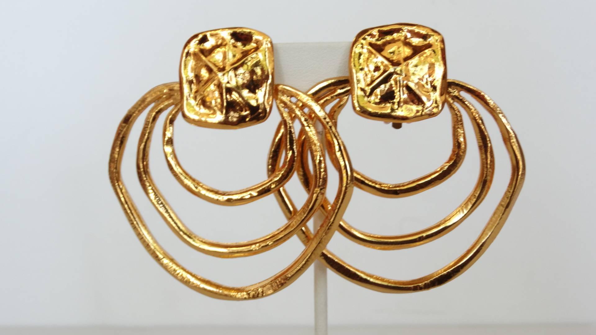 A triple hoop earring designed by the fabulous designer Christian Lacroix. Three hoops combined into one. Clip ons are in great condition. Signed Christian Lacroix on the earrings. Earrings are 3 inches long by 2.50 inches wide. These earrings are